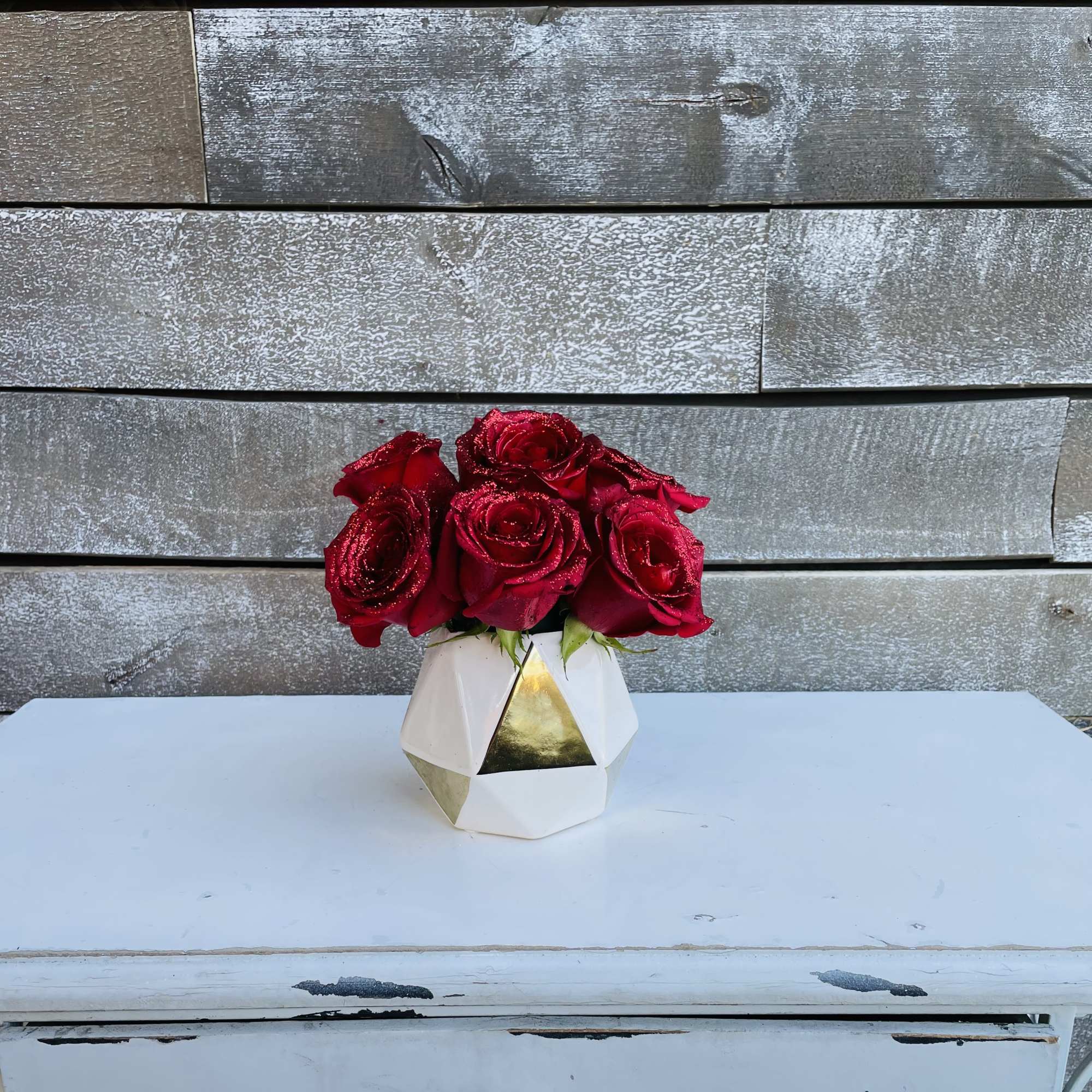 Half dozen Glittered red roses in a small bud vase Half dozen Glittered red roses in a small bud vase