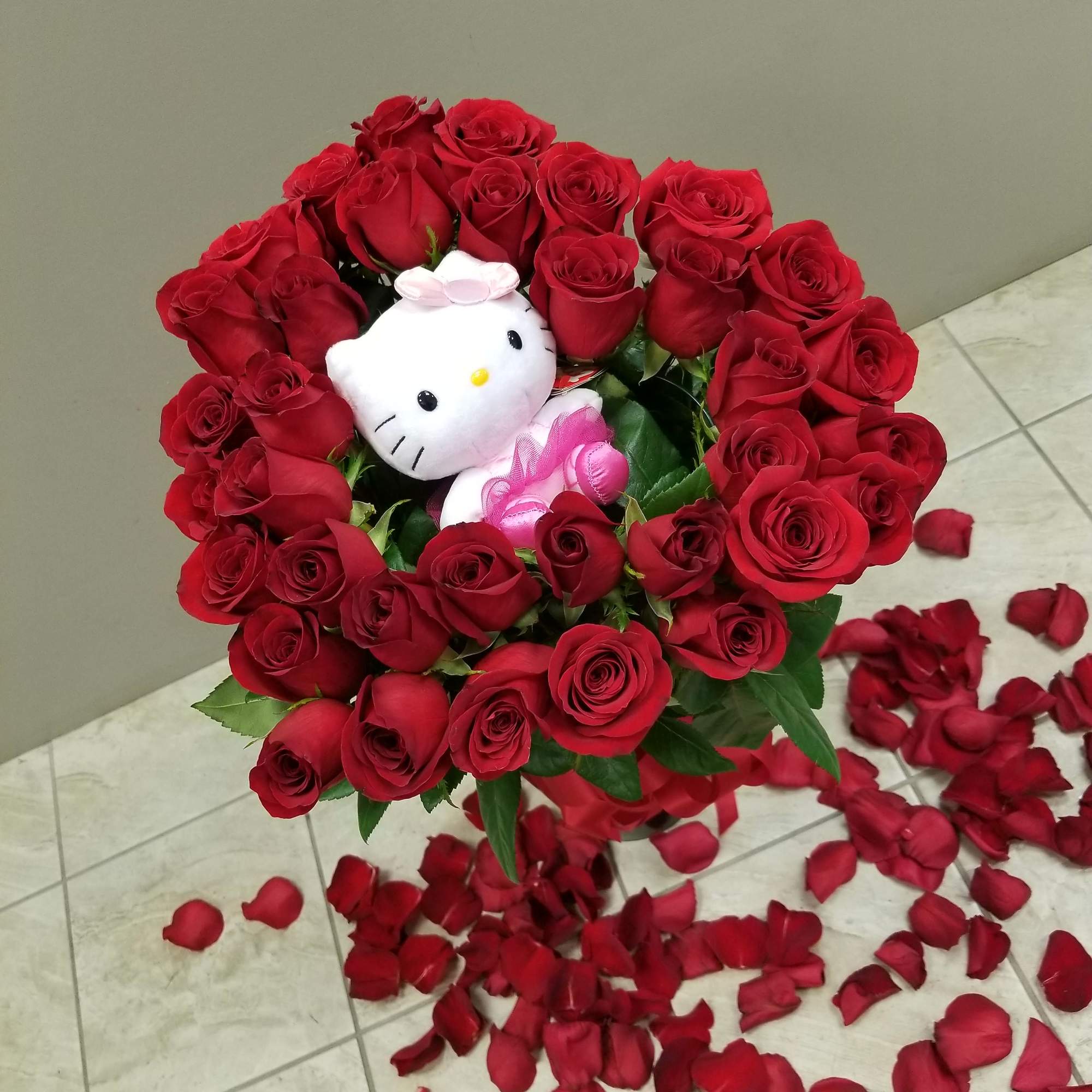 Long stem roses in a heart shaped bouquet tied with a satin