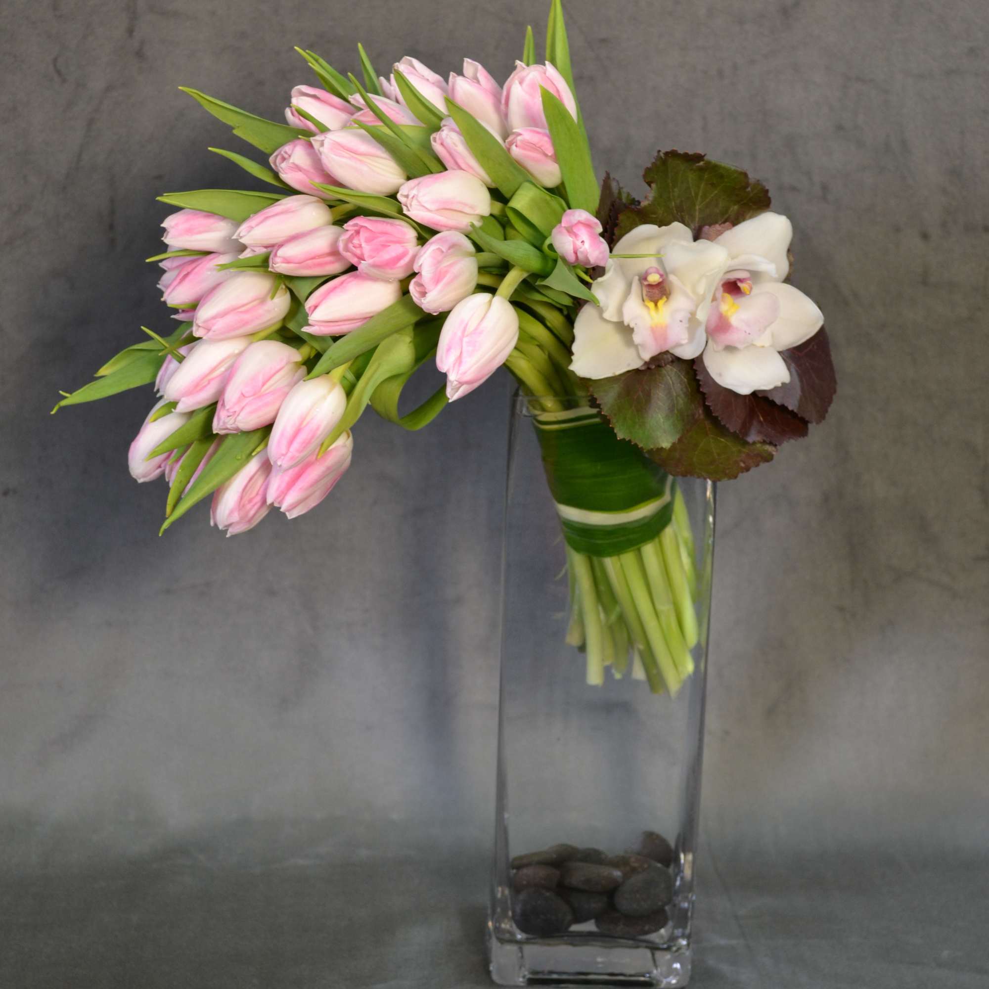 Blush Tulips beautifully falling to the side as a cascade with Cymbidium