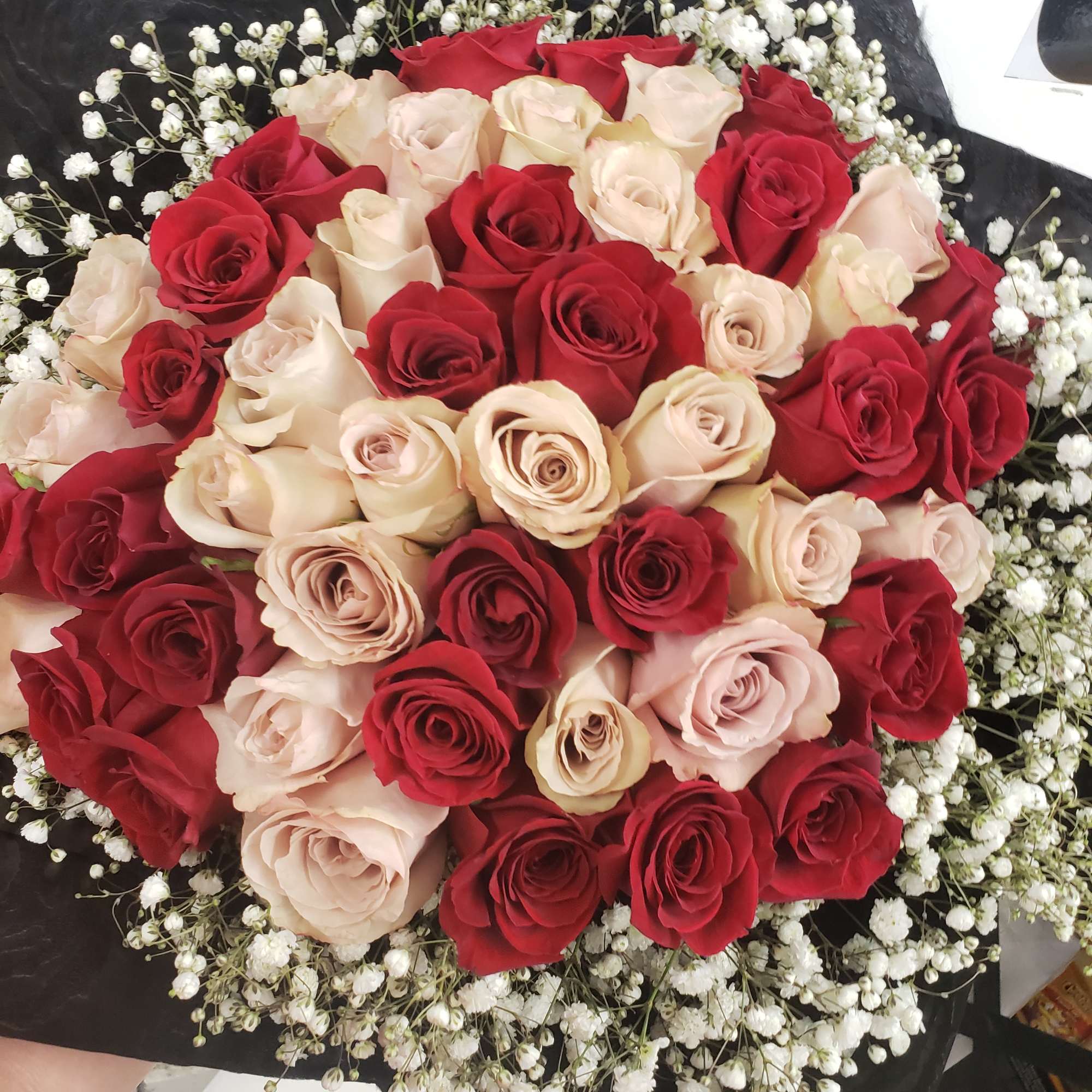Hand tied bouquet with rose 
Red and quicksand, baby breath touch!