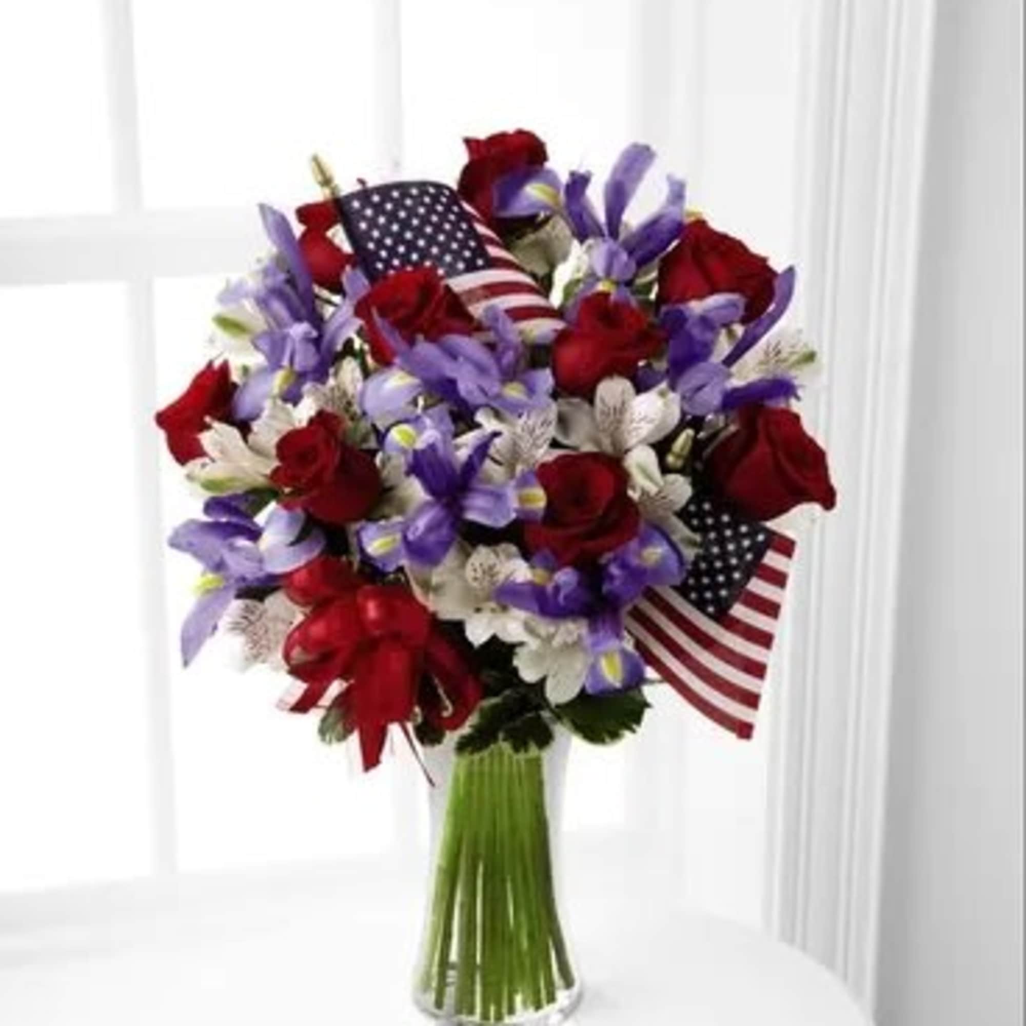 Bright red roses mingle with blue iris, white Peruvian lilies and assorted Bright red roses mingle with blue iris, white Peruvian lilies and assorted