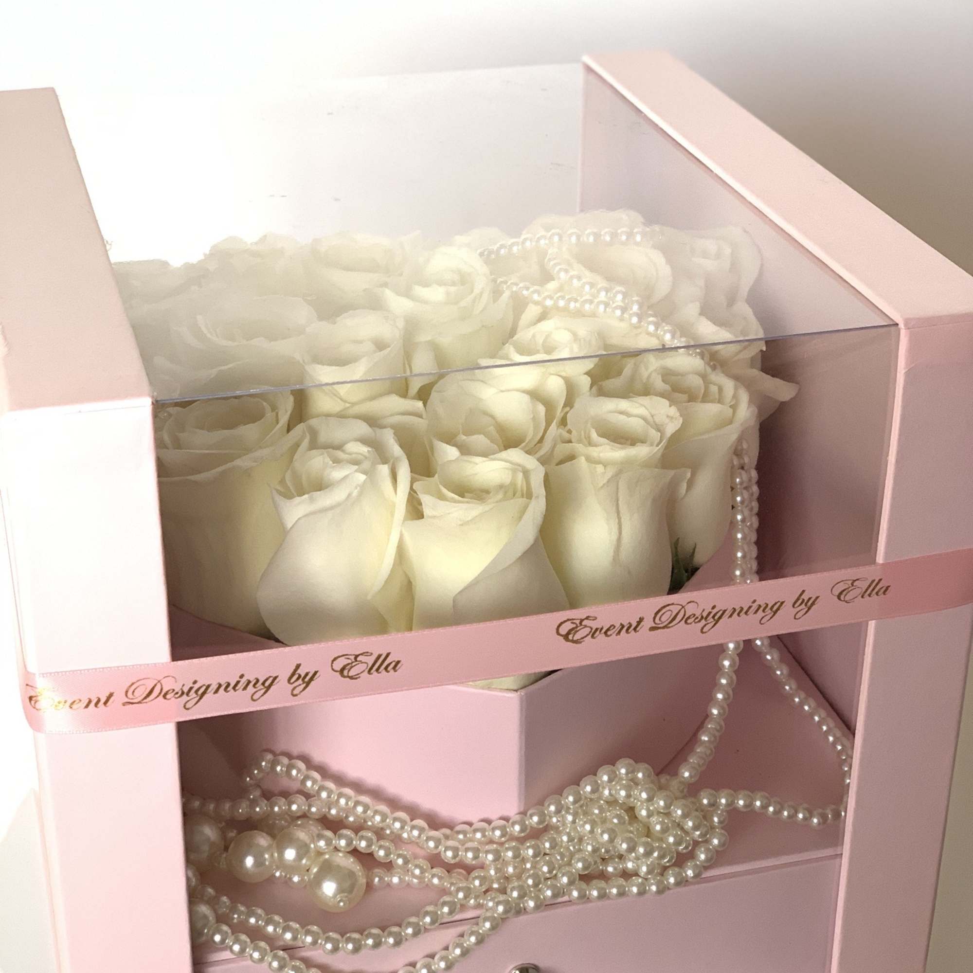 Fresh rose heart in a floral box in addition of a pearl