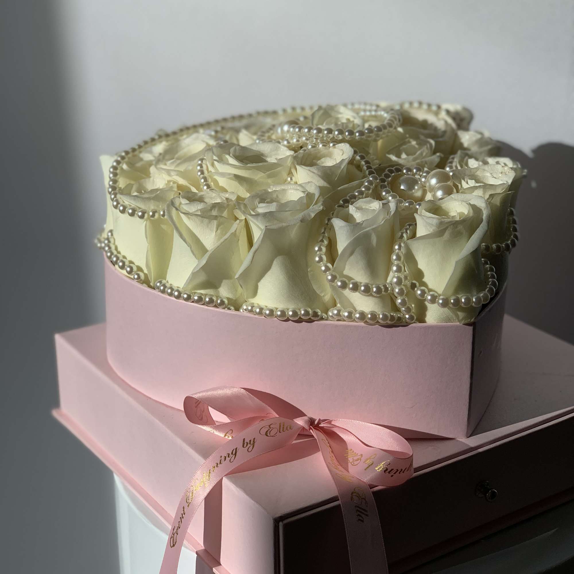 Fresh rose heart in a floral box in addition of a pearl