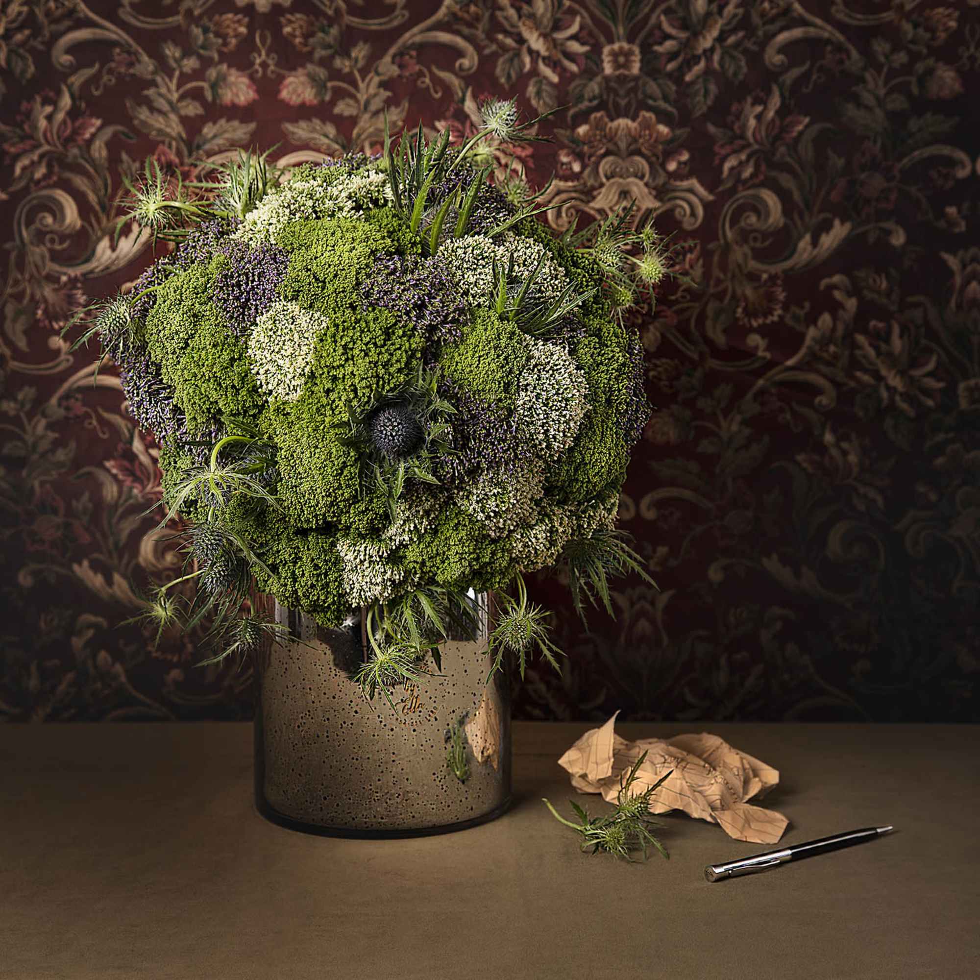 Floral ball arrangement in a glass vase designed in English style for