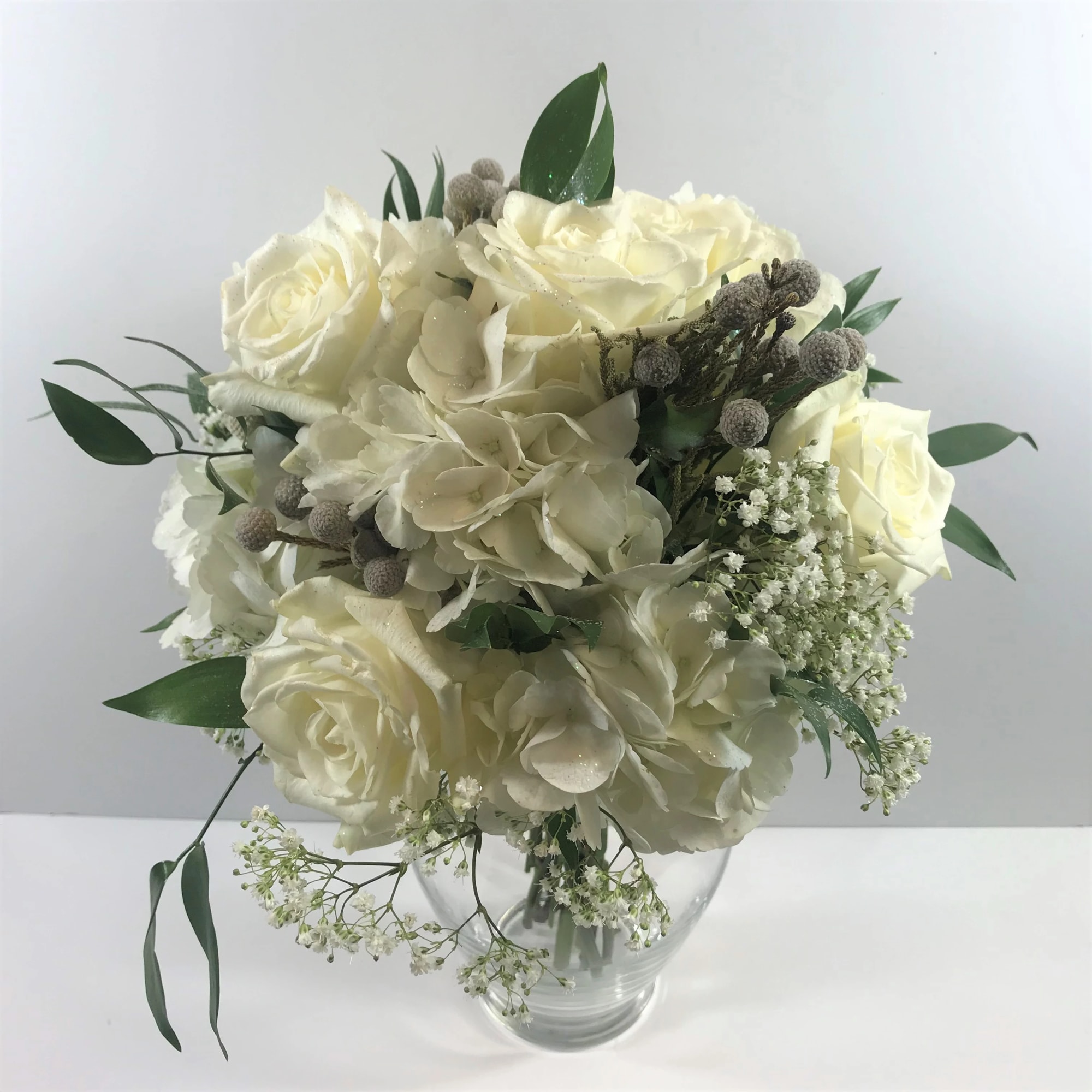 This prom clutch includes hydrangea, roses and silver brunia accents.  This