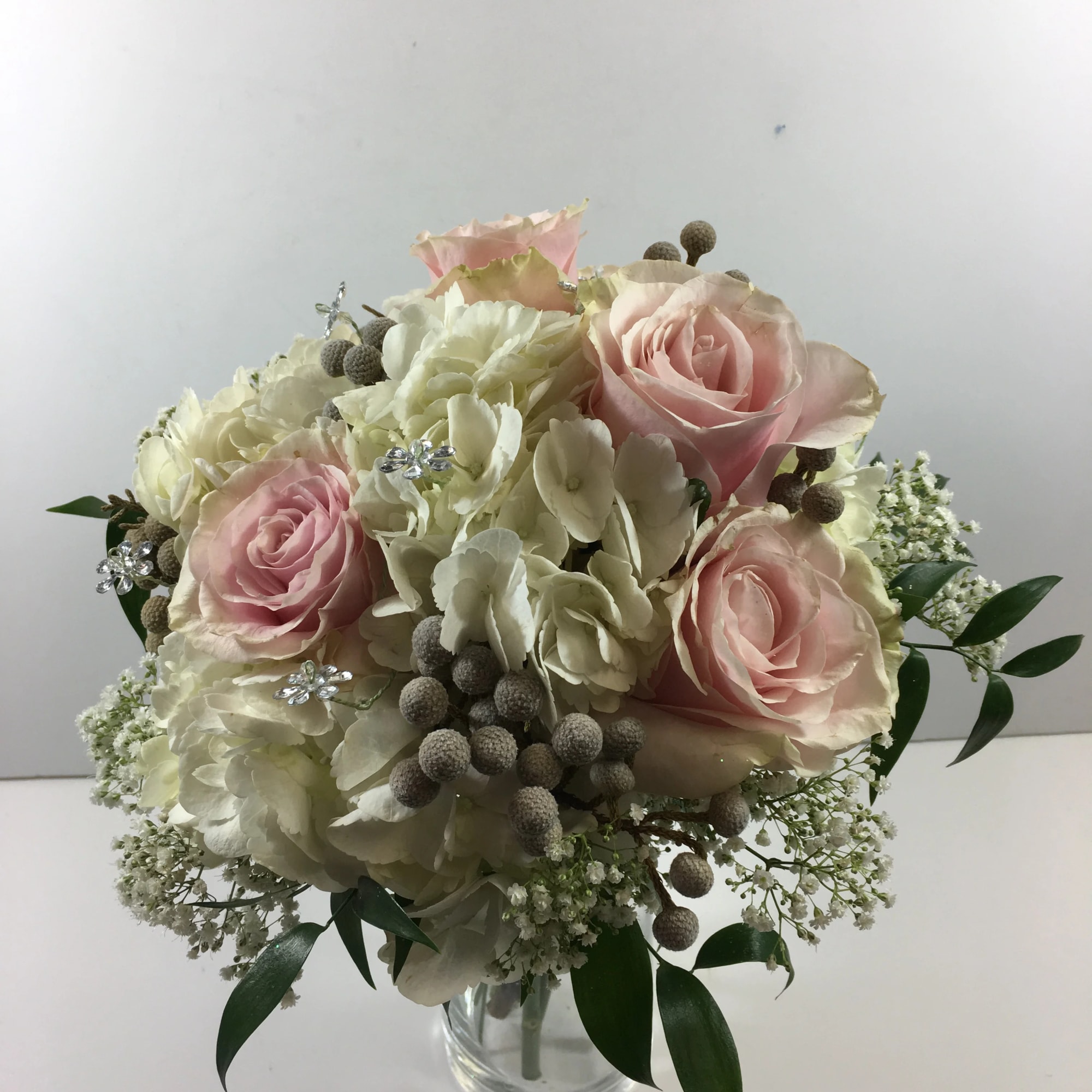 This prom clutch includes hydrangea, roses and silver brunia accents.  This