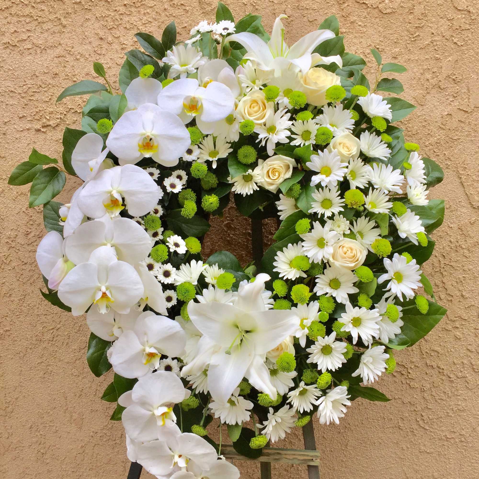 Standing wreath including orchid, lily, rose... and accents.
STANDARD: FIRST PHOTO
DELUXE: SECOND PHOTO