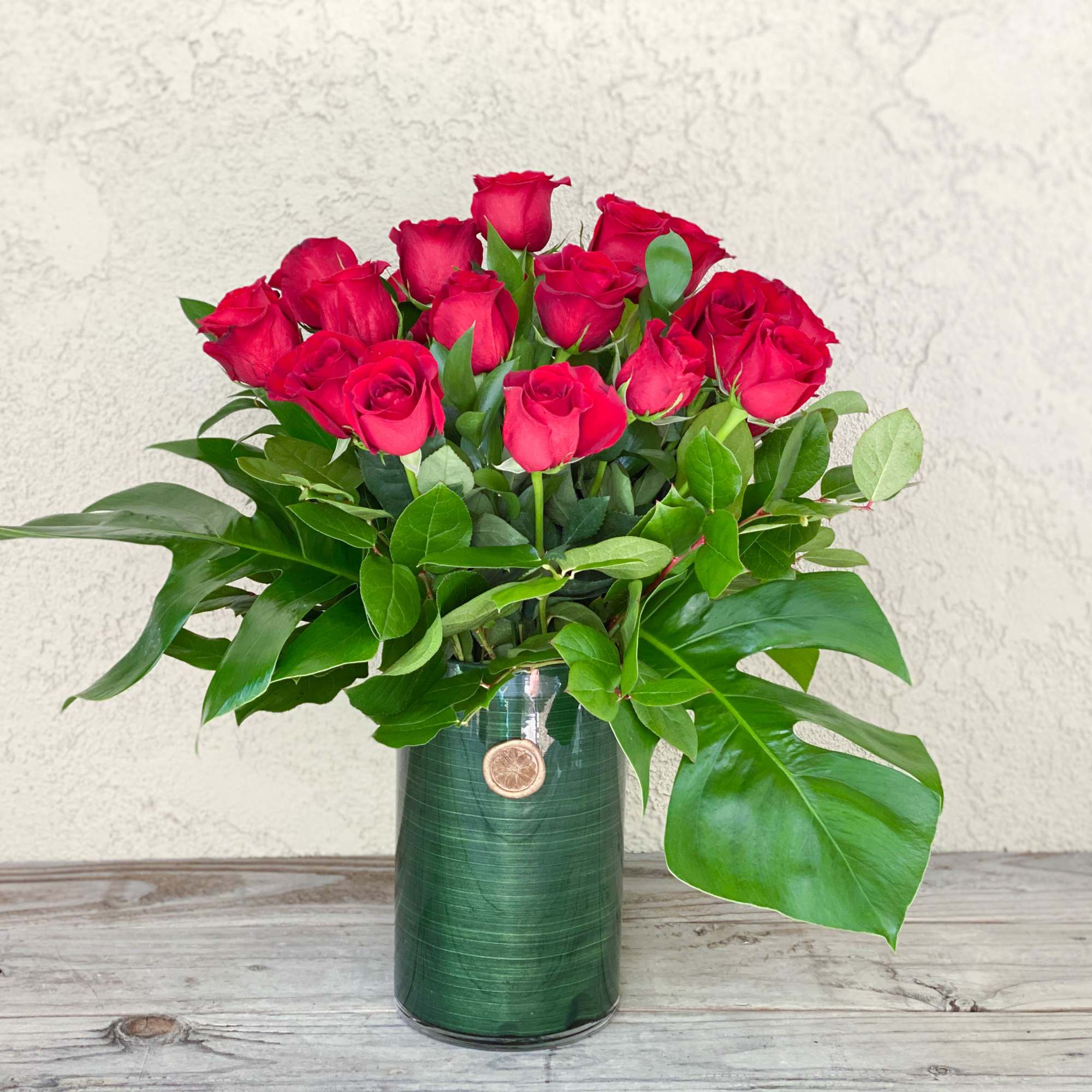 This timeless classic features two dozen red roses accented with leafy greens This timeless classic features two dozen red roses accented with leafy greens