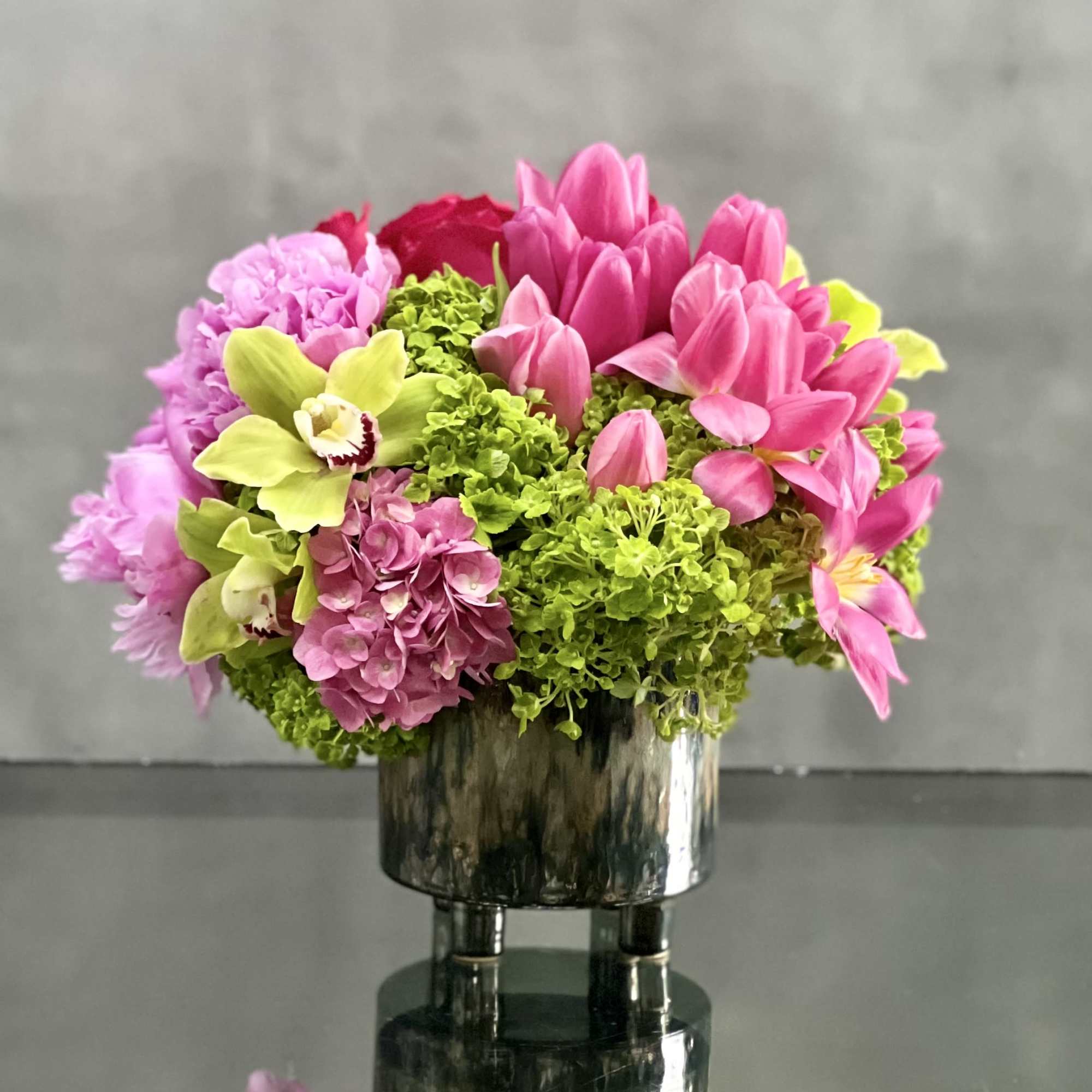 This delightful arrangement is an artistic combination of pink floral favorites. Delicate
