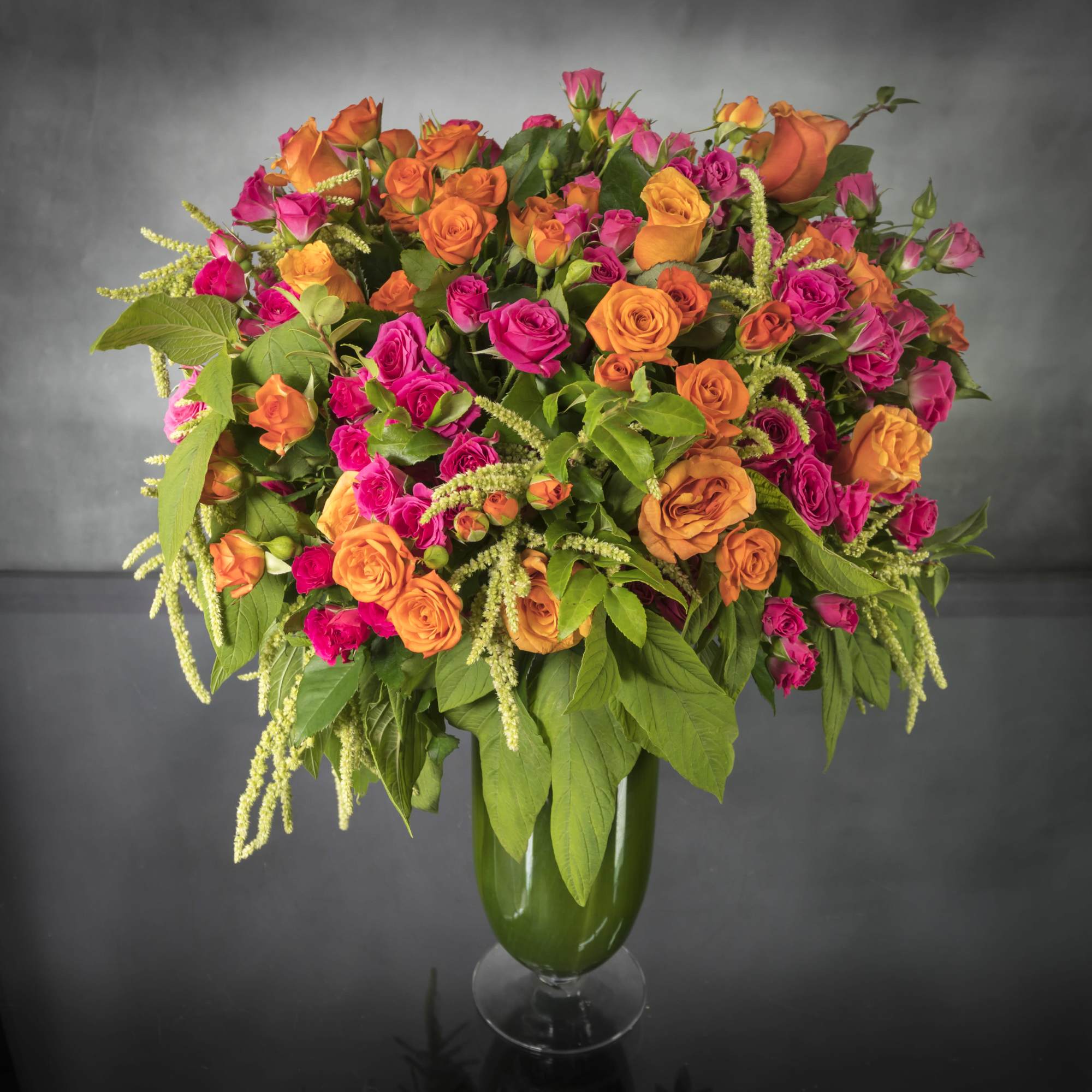 A vibrant mix of gorgeous orange and hot pink Roses in a