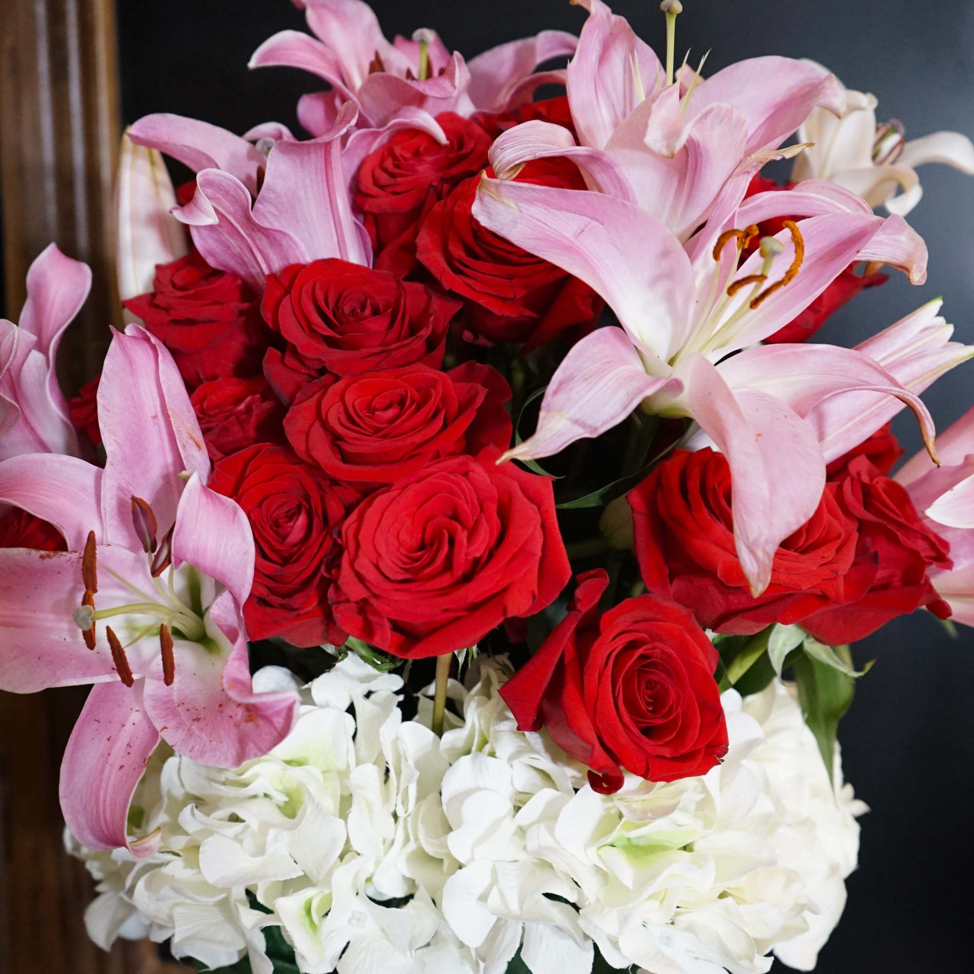 A Dozen Red Roses with Lilies and Hydrangeas to romance the air.