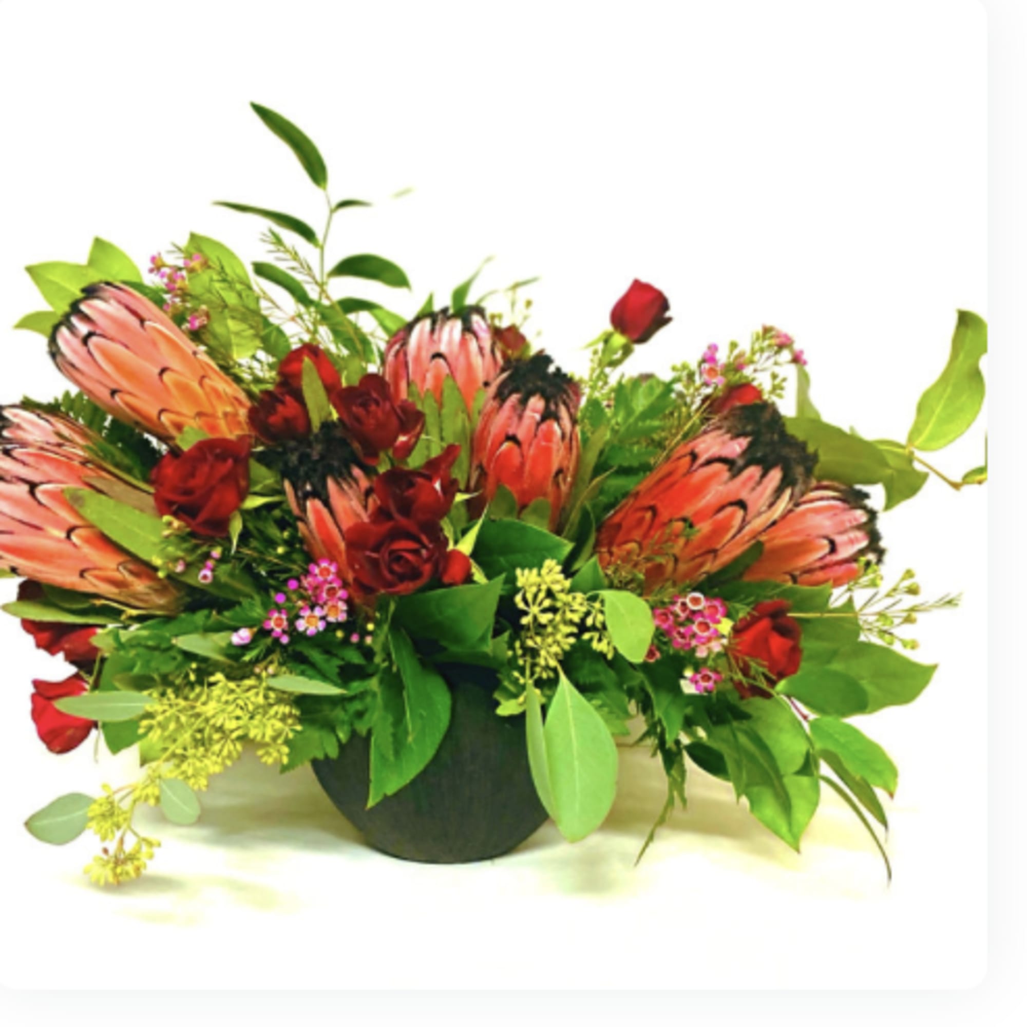 Bold Tropical blooms designed with modern accents of roses and tropical greens.