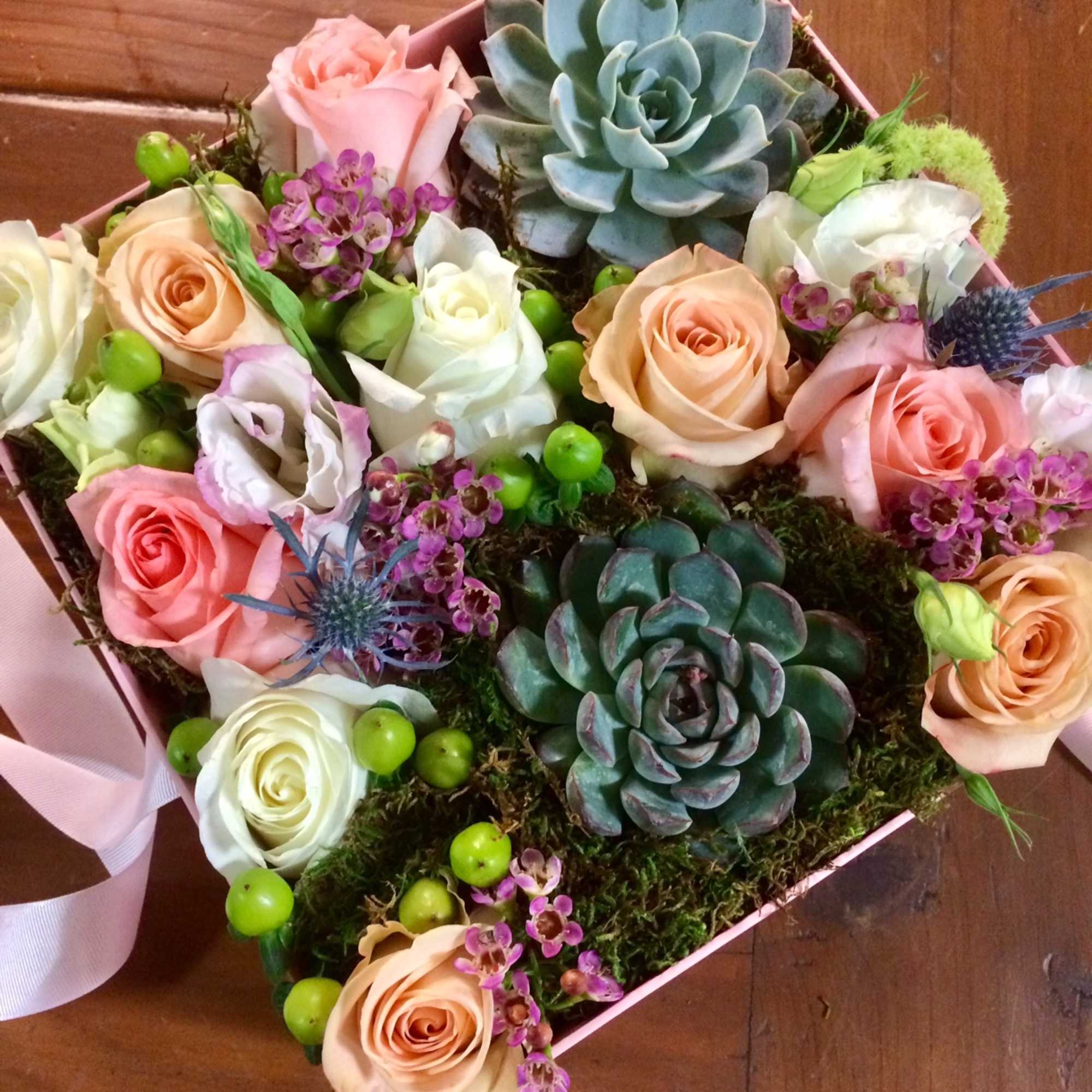A great gift for a special one with succulents, roses, lisianthus, wax