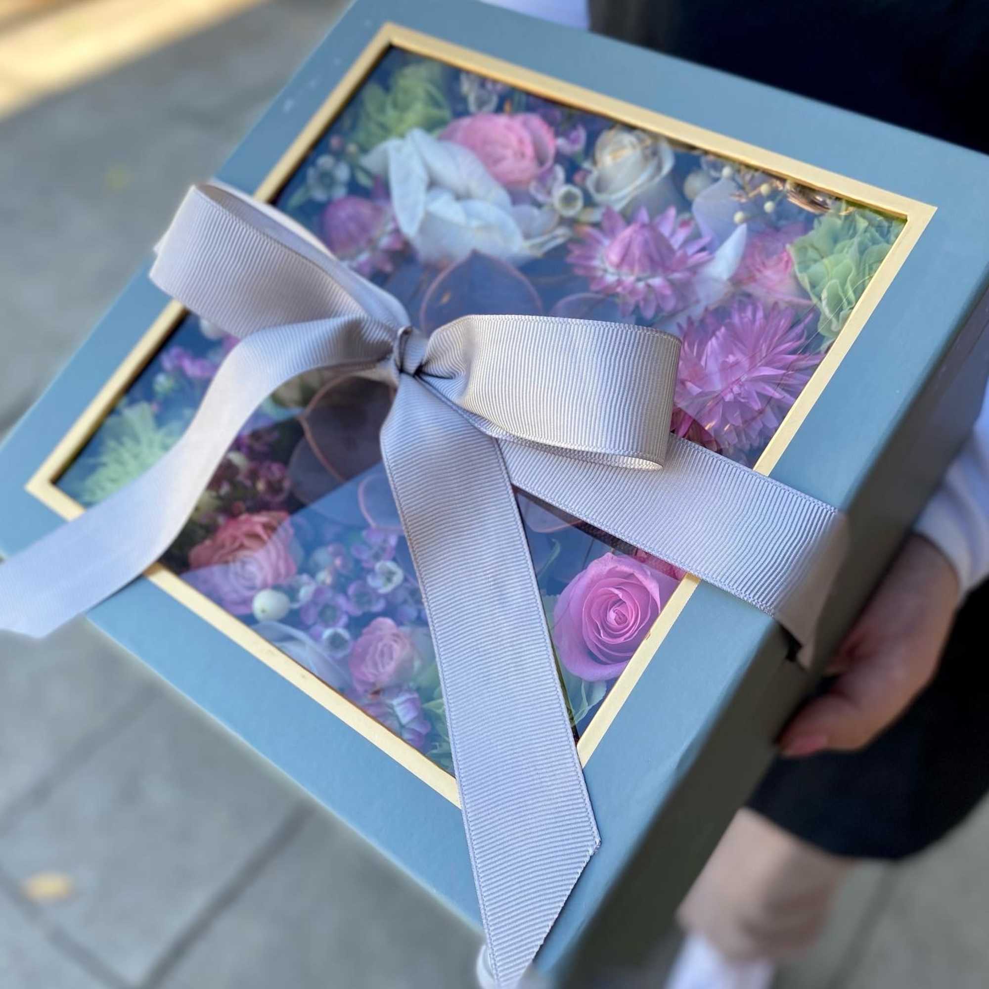 Mix flowers with a succulent arranged in a box. 
Box color may