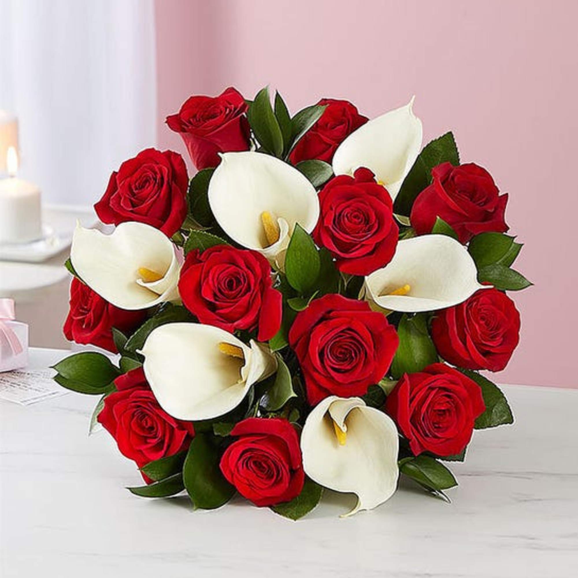 This beautiful hand arranged bouquet comes with roses and calla lilies and