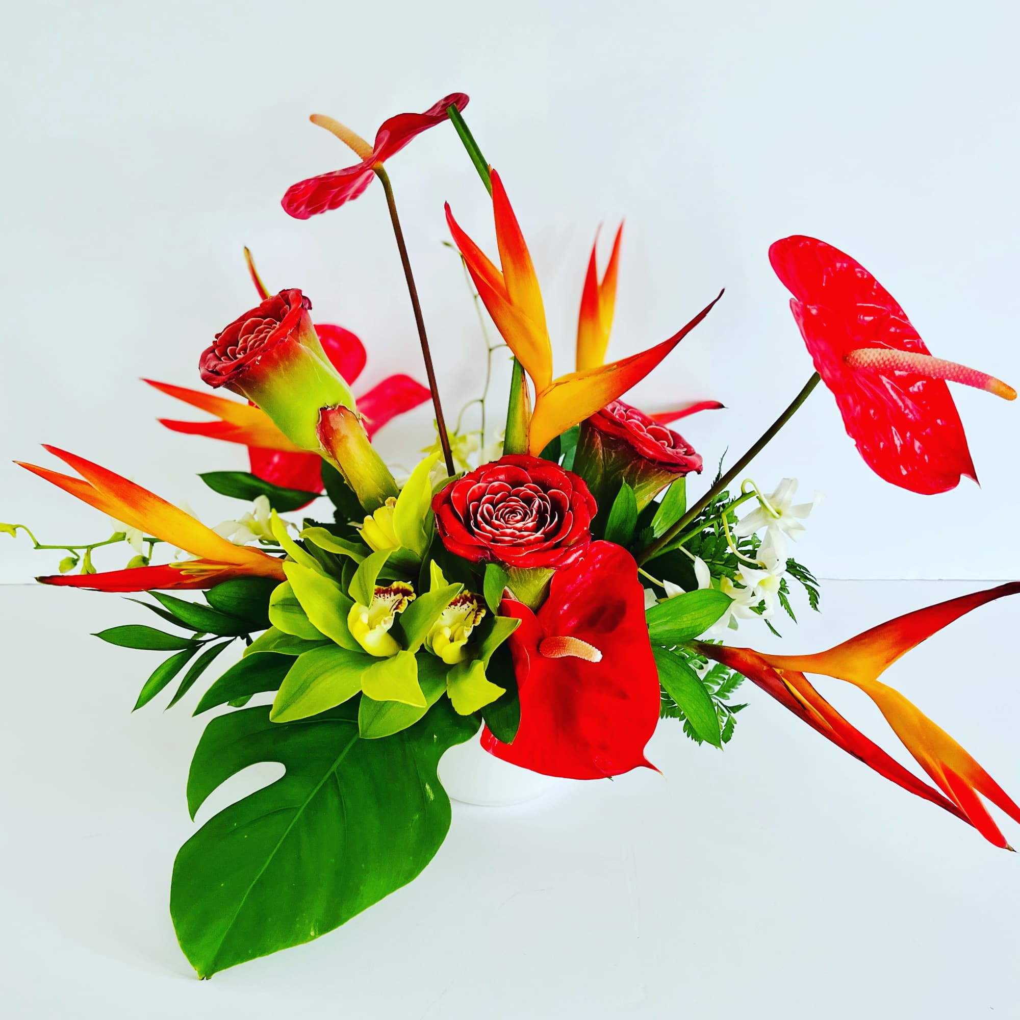 A vibrant arrangement designed with jewel&nbsp;tone&nbsp;tropical blooms and foliage. &nbsp;Modern in it&#039;s