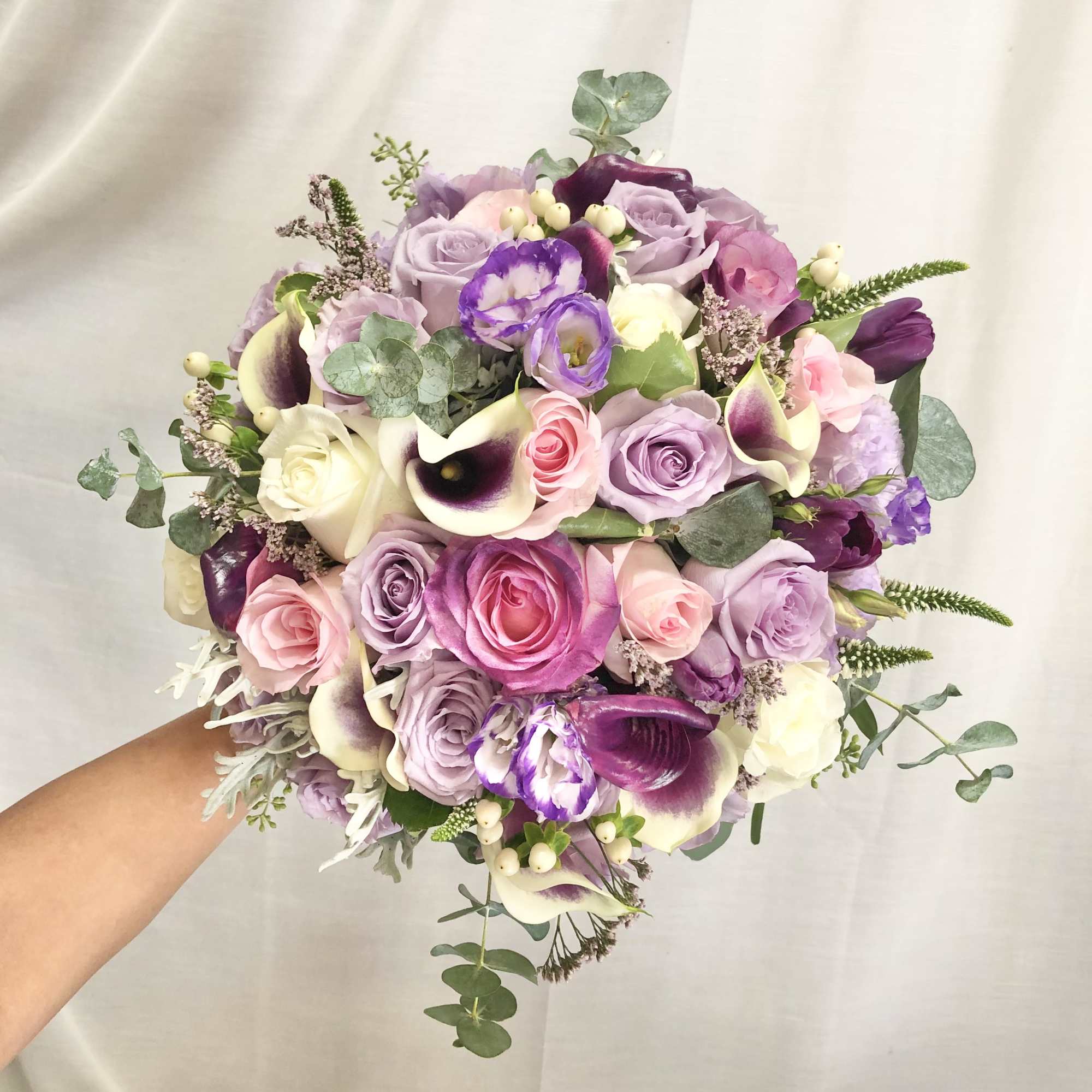 Beautiful bouquet arrangement with mixed lavender, pink, and white flowers with silver