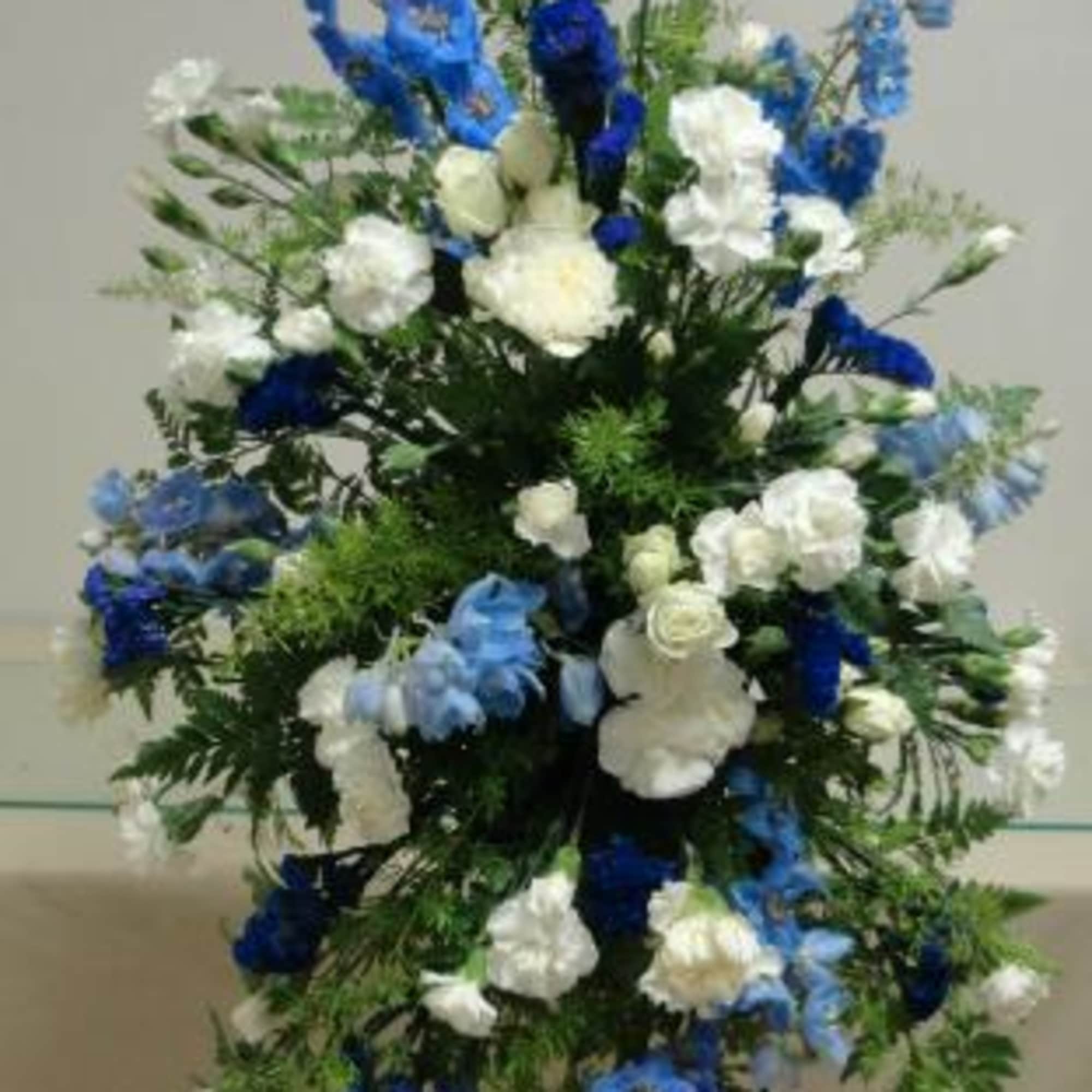 Standing spray of blue and white flowers. Standing spray of blue and white flowers.