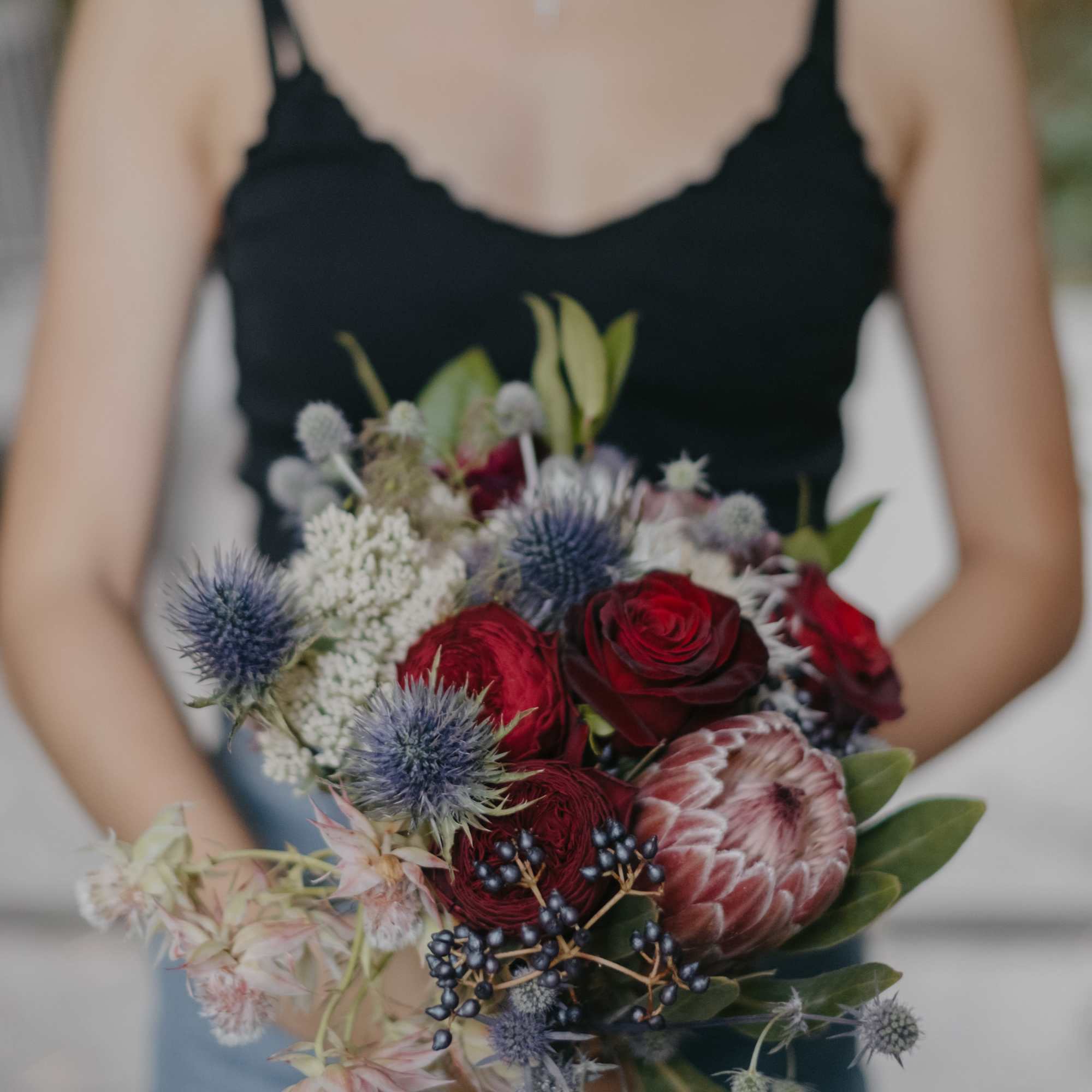 Roses, protea, carnations, thistles