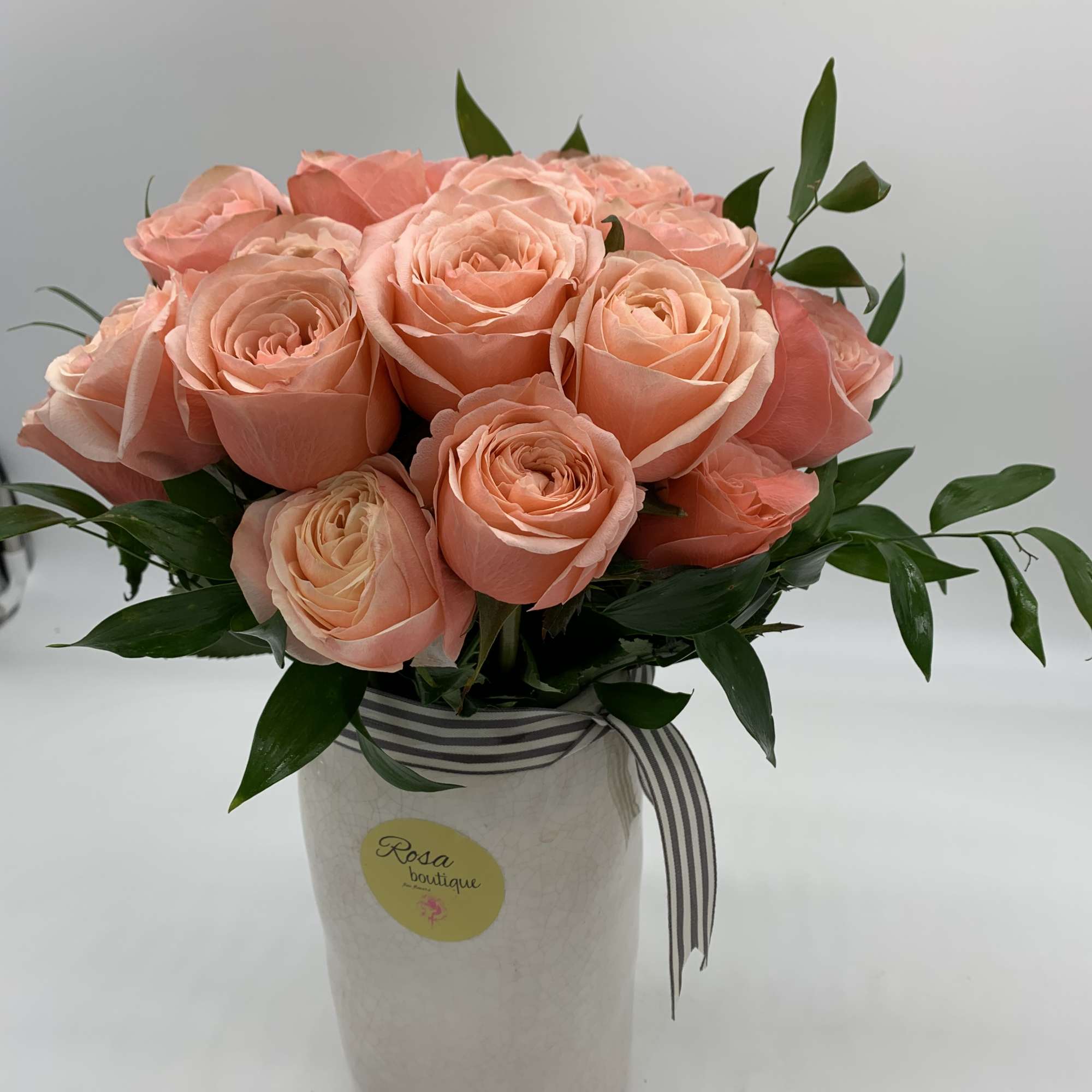 2dozen of peach roses Sitting in a ceramic vase 8&rdquo; fall and