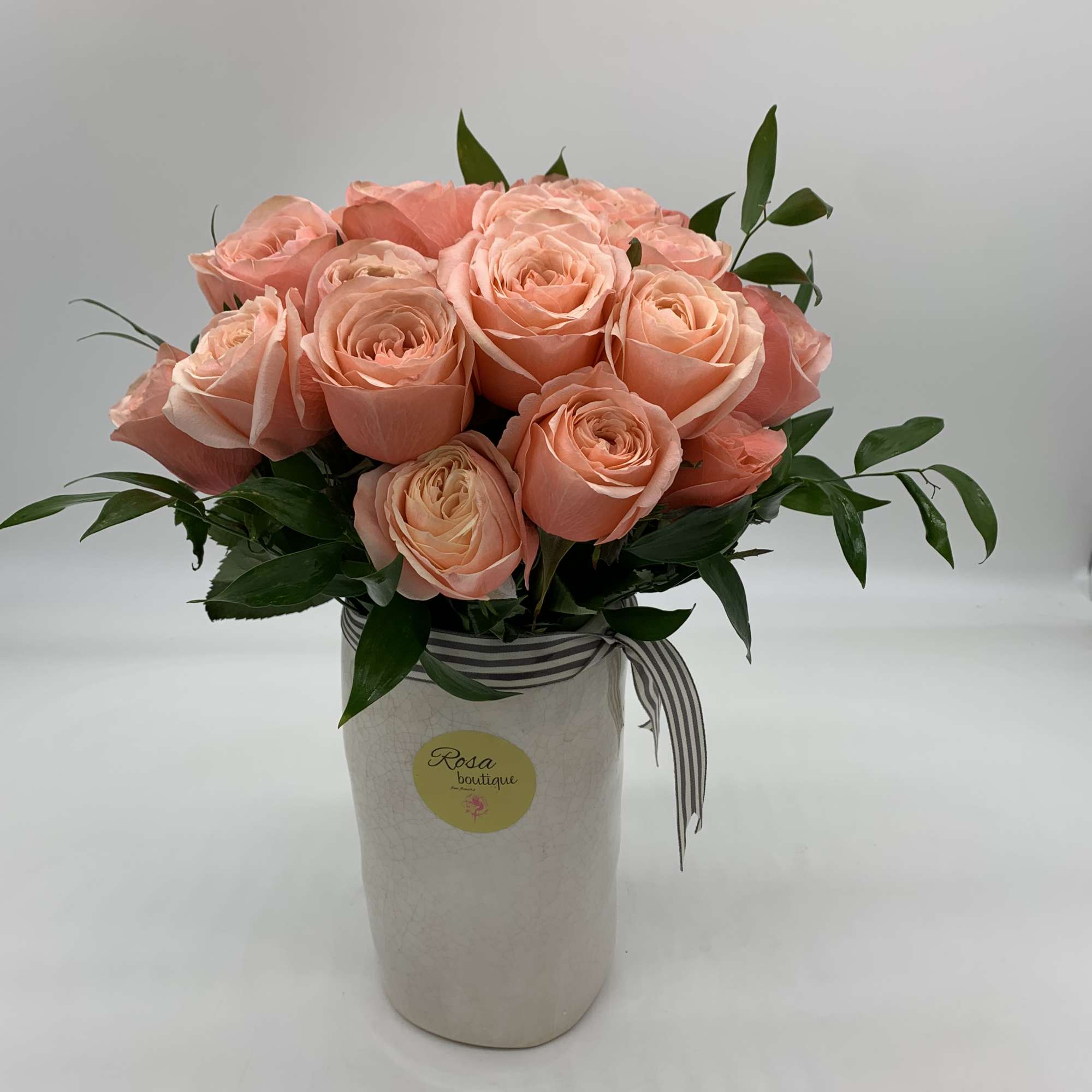 2dozen of peach roses Sitting in a ceramic vase 8&rdquo; fall and