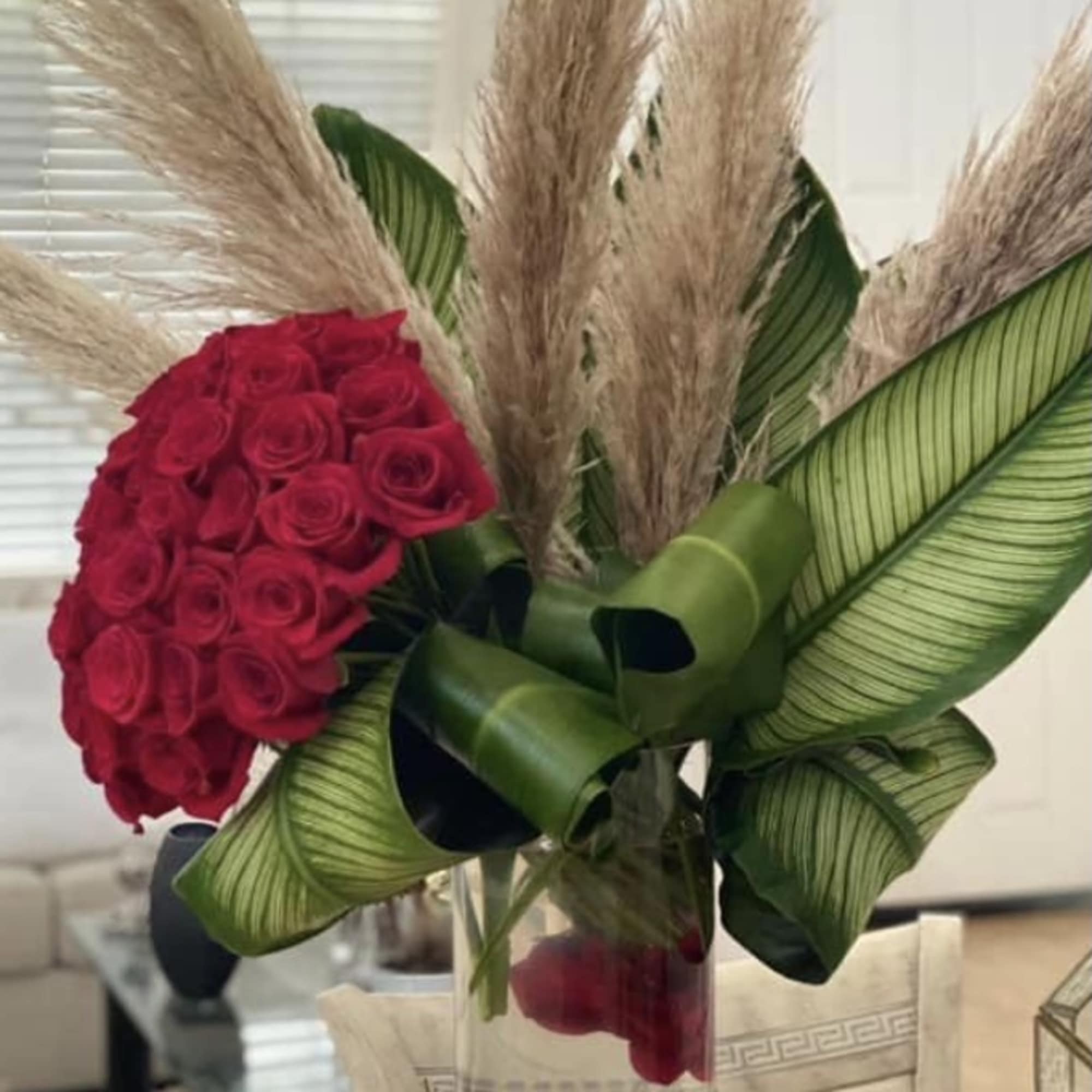 50 beautiful Ecuadorian red roses sitting in a elegant  cilinder 