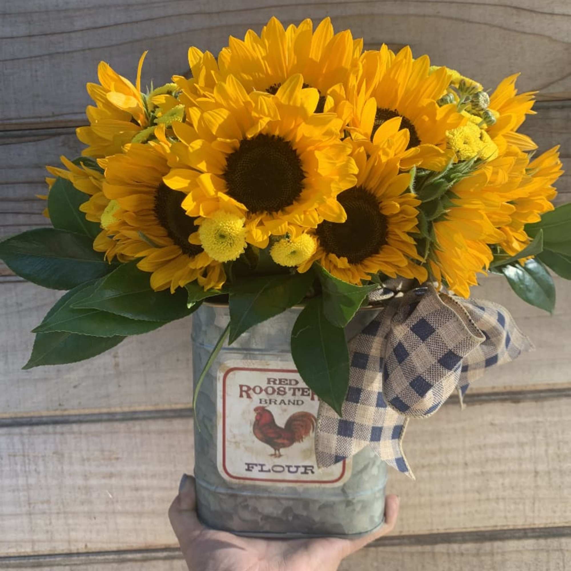 This bright arrangement is made of the portion of 18 sunflower sitting