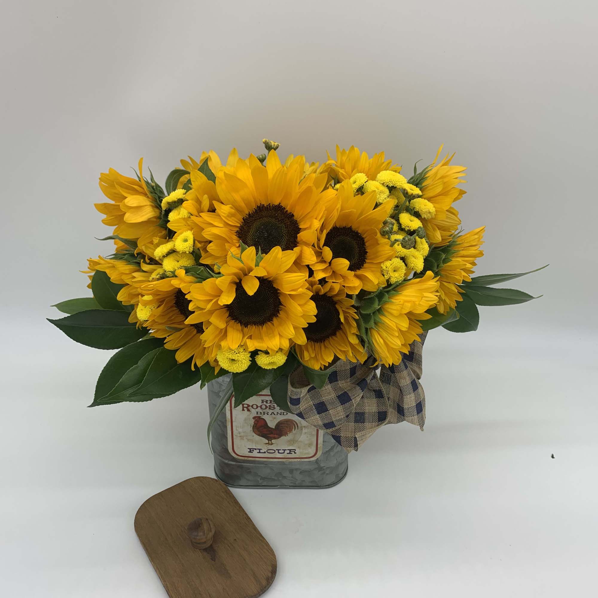 This bright arrangement is made of the portion of 18 sunflower sitting