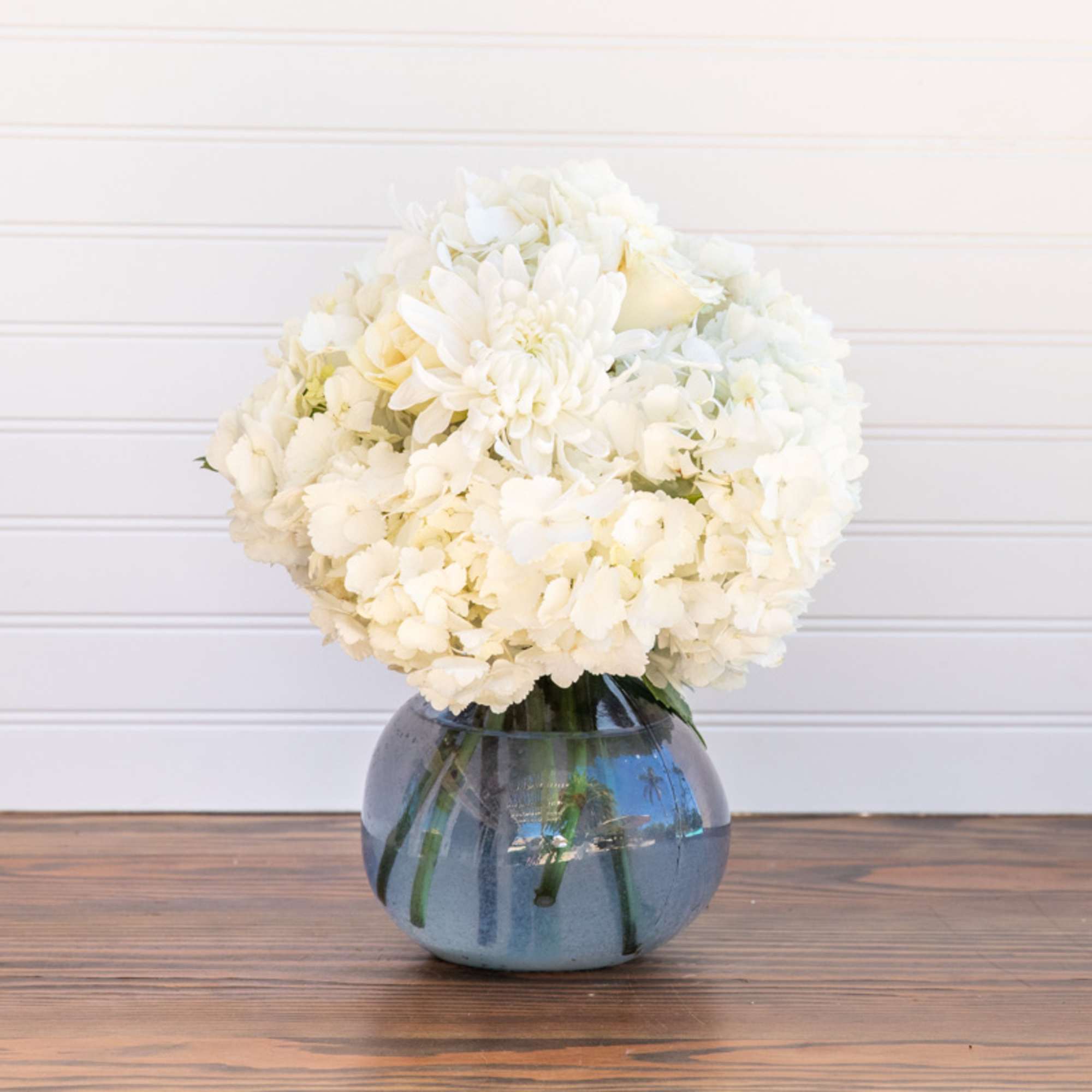 Beautiful Hydrangeas and a few white roses and mums in a Recycled