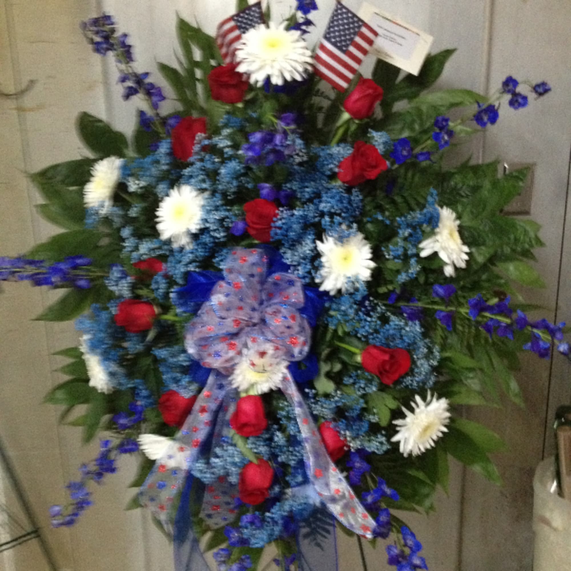 * Red roses * Blue delphinium * Gyp * White cremones *