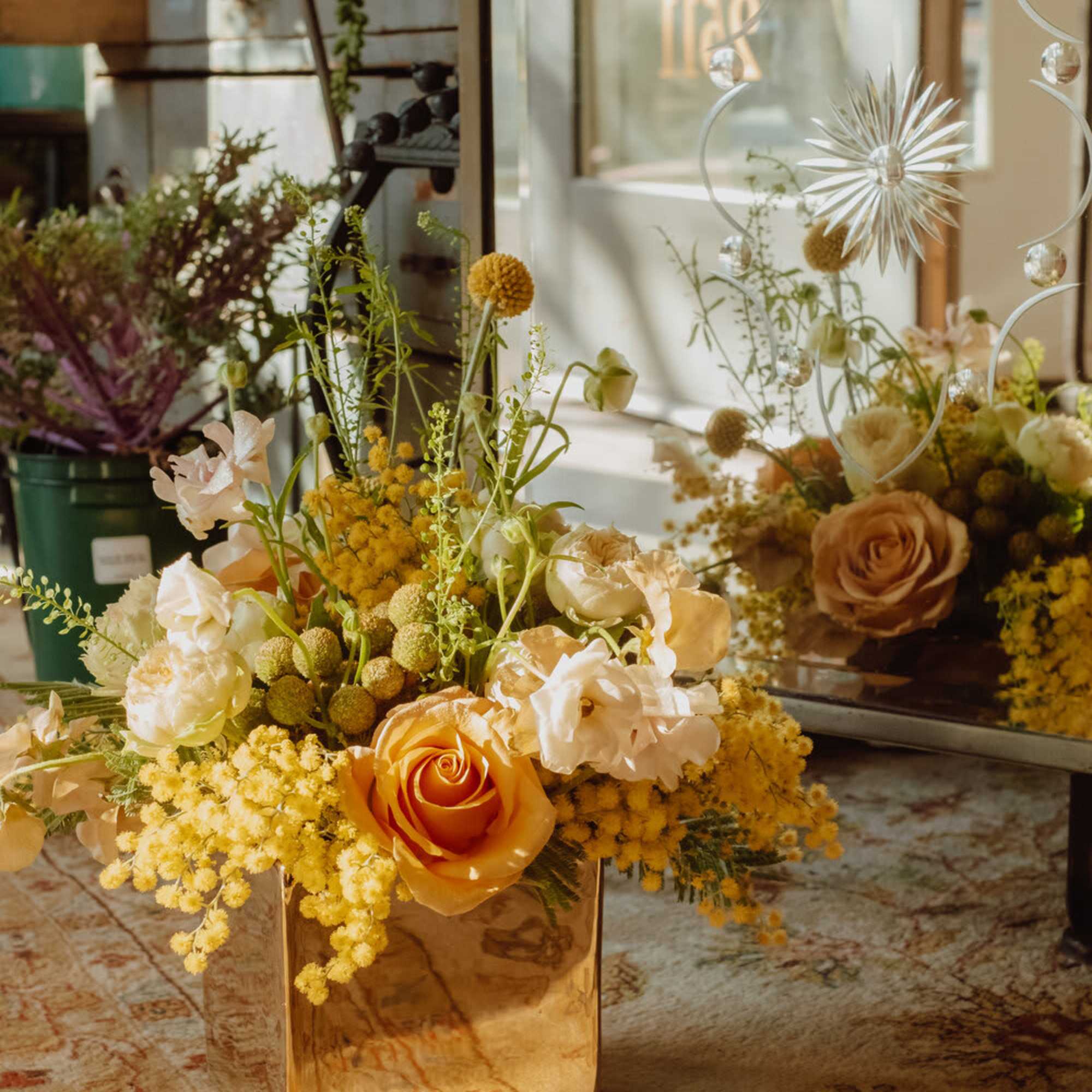 Filled with bright yellow and orange tones, this sunny arrangement will be