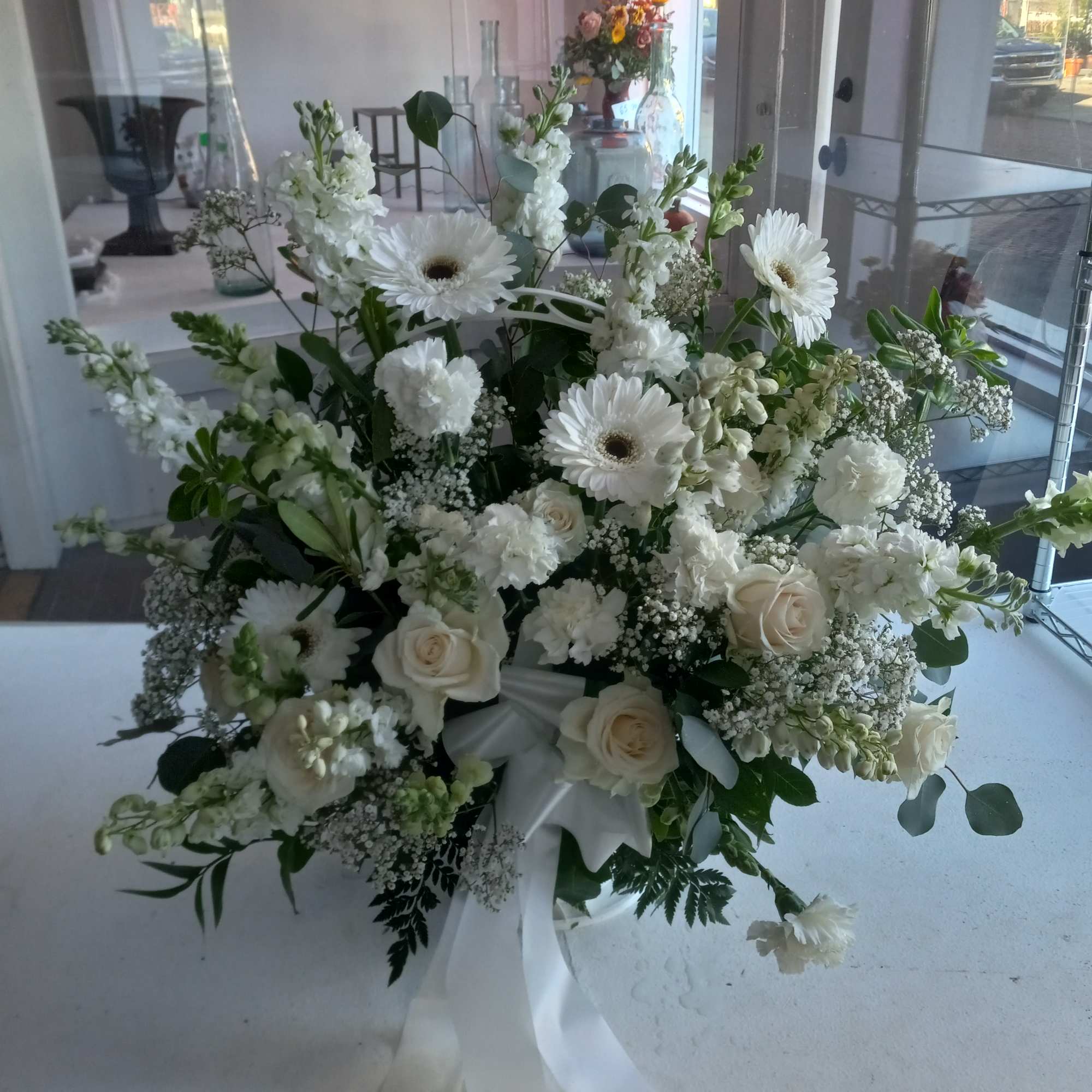 Beautiful al white funeral basket in deepest sympathy 