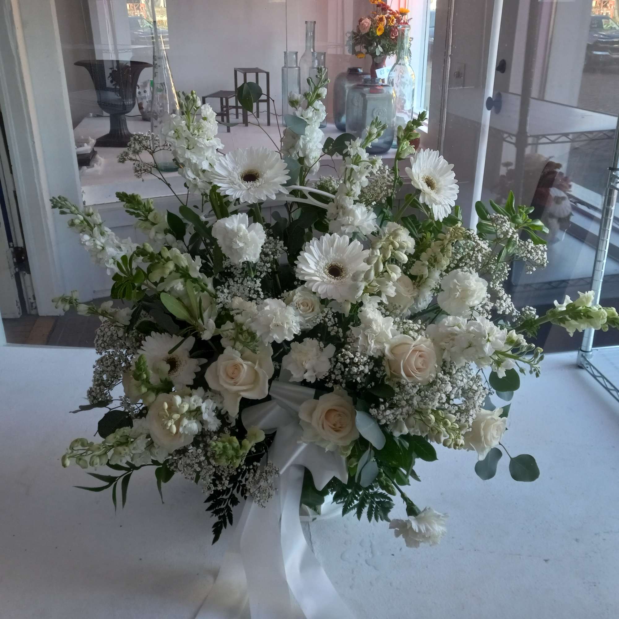 Beautiful al white funeral basket in deepest sympathy 