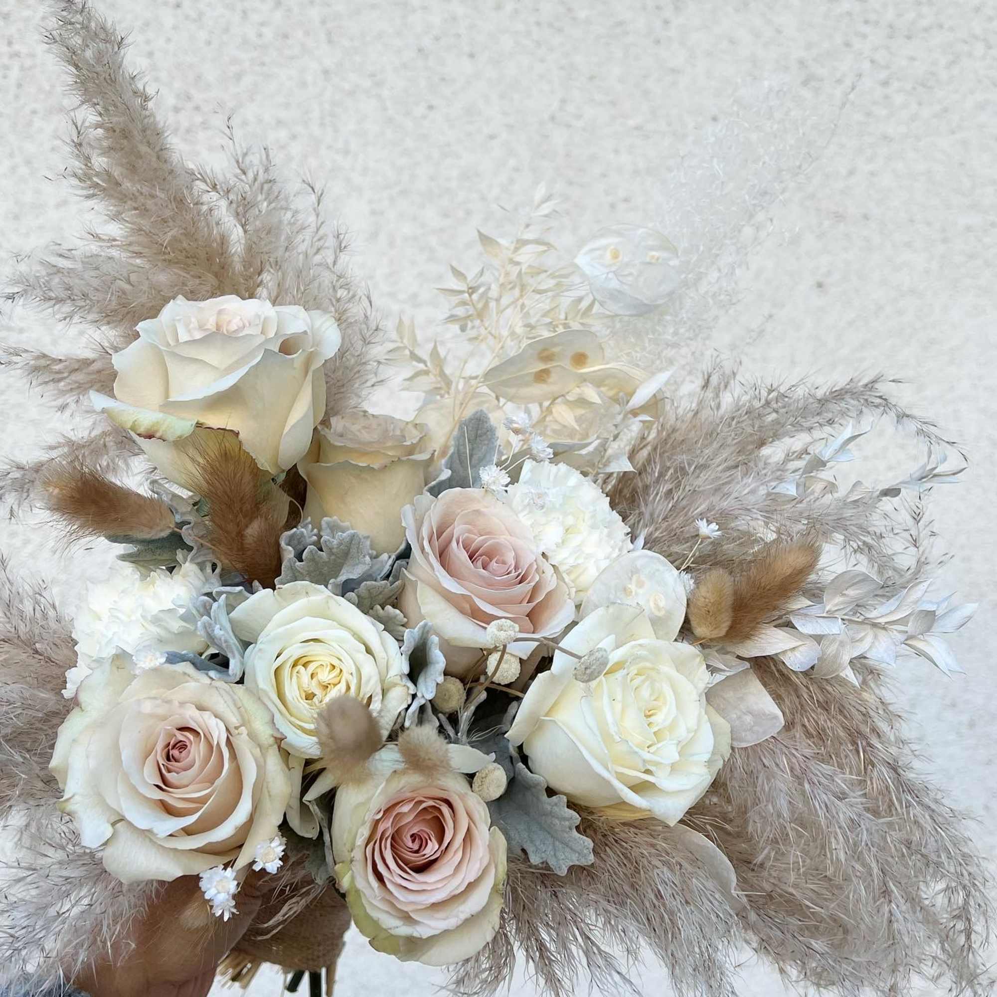 mixed of dried and fresh flowers in a natural and white bouquet.