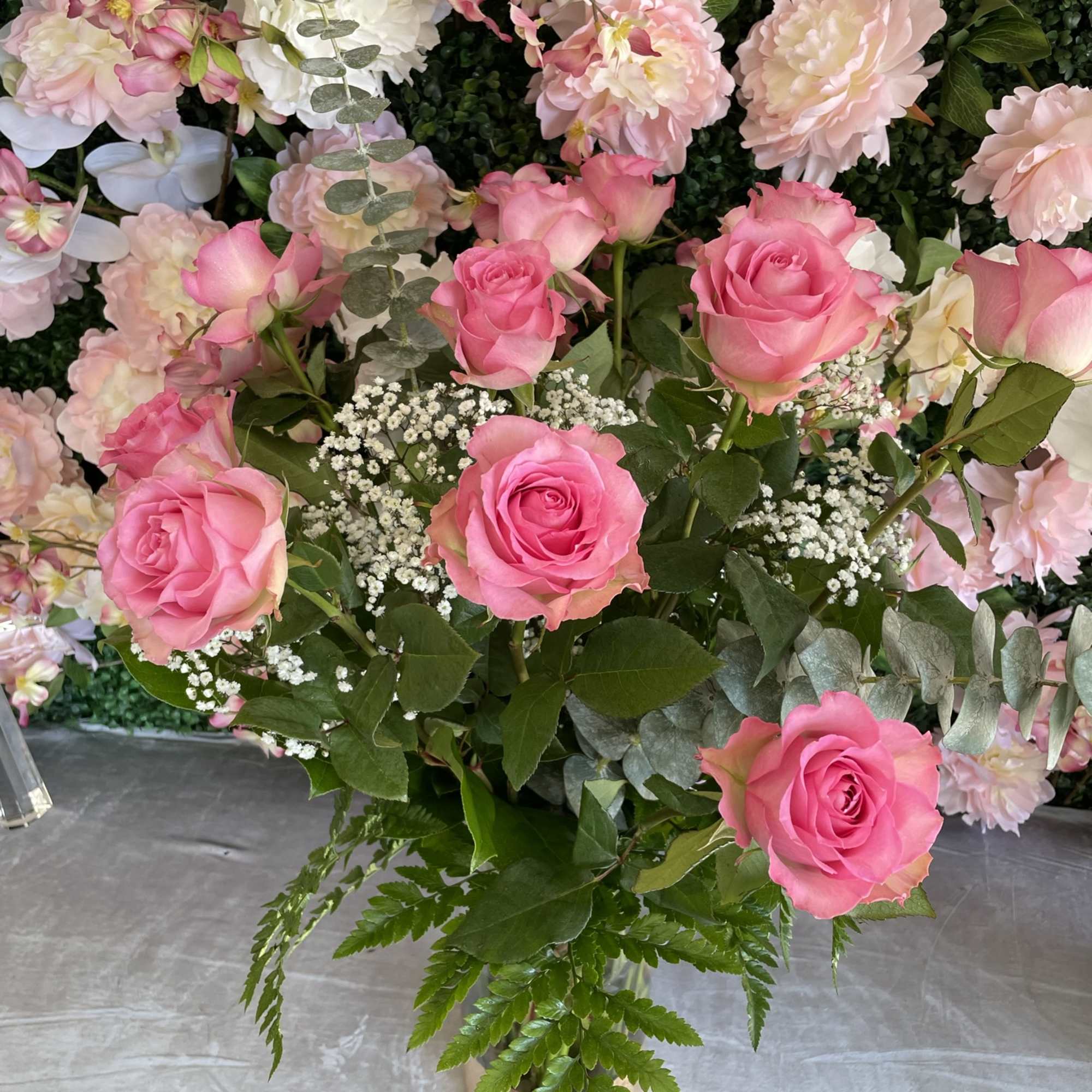 This sweet arrangement has pink roses and fresh greens 