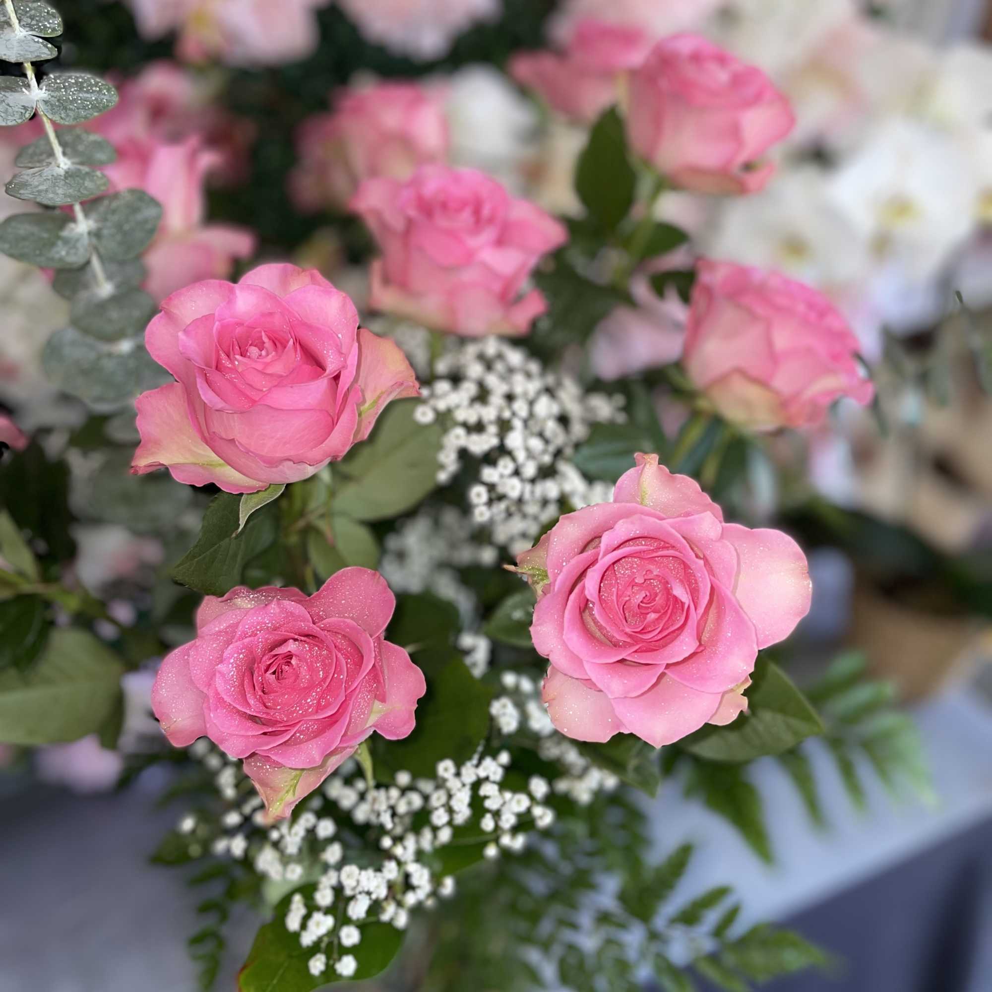 This sweet arrangement has pink roses and fresh greens 