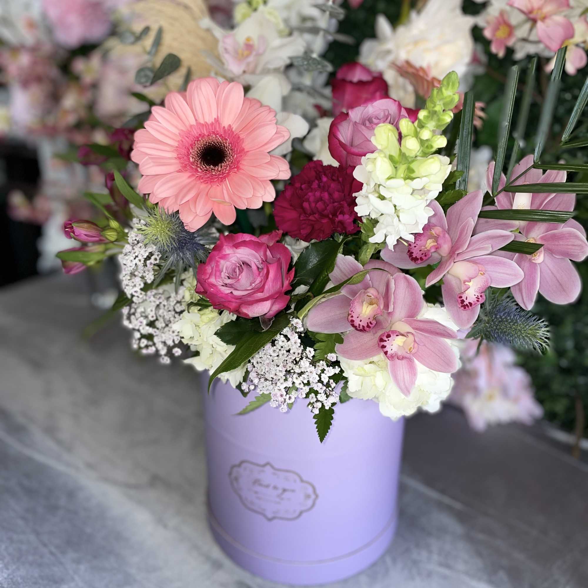 This beautiful arrangement has the perfect colors, pink gerbera, lavender roses, white