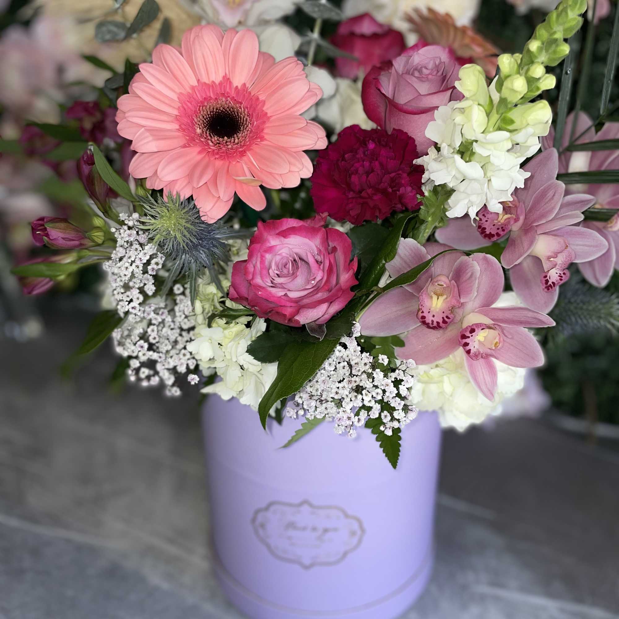 This beautiful arrangement has the perfect colors, pink gerbera, lavender roses, white
