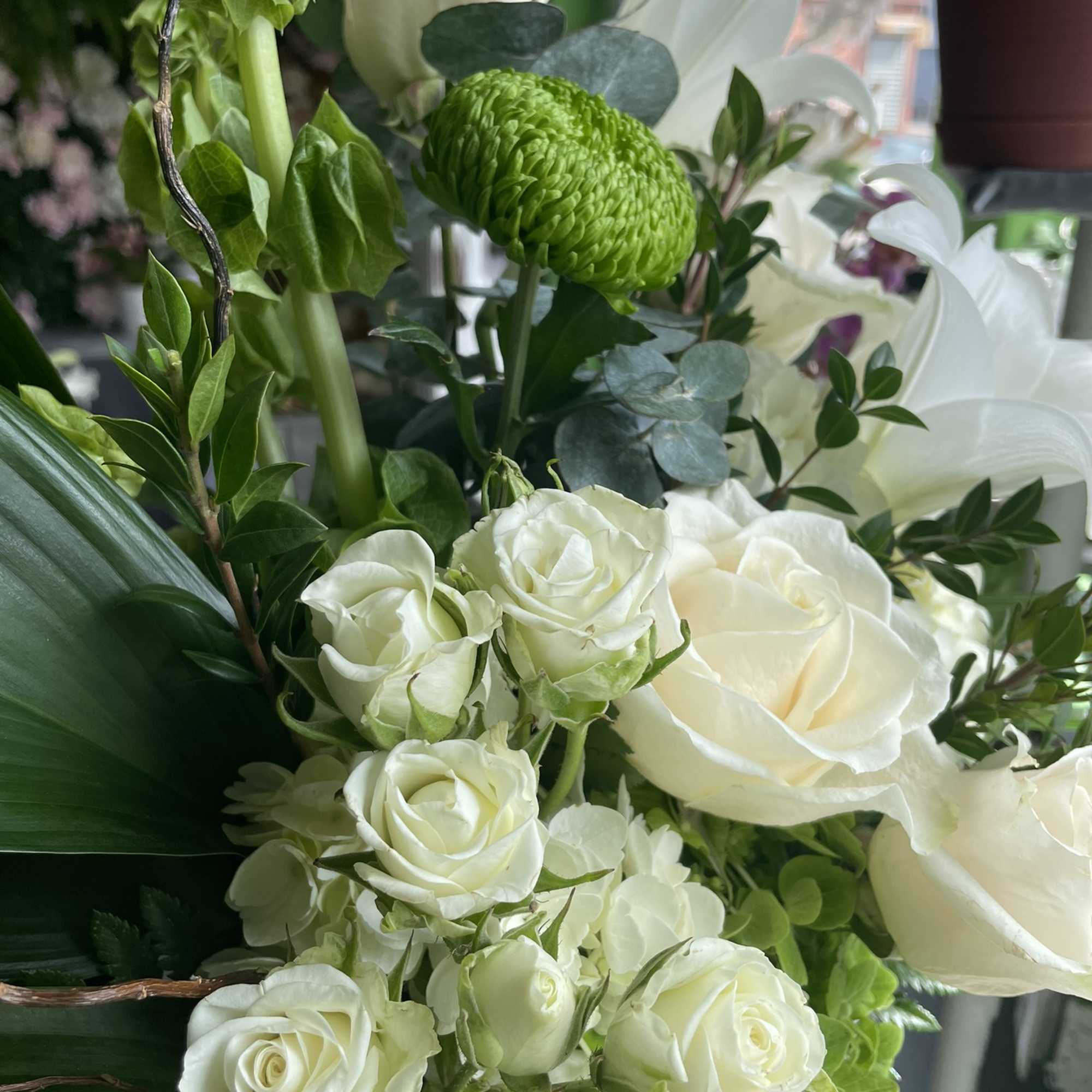 This beautiful arrangement has gorgeous white fresh flowers and white lilies, white