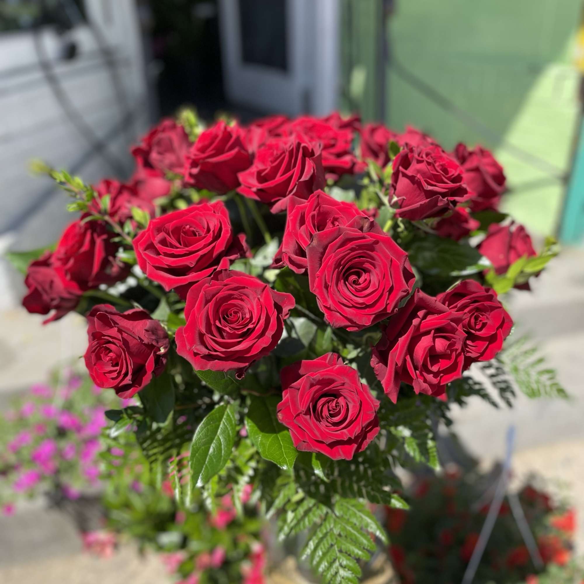 This gorgeous arrangement has beautiful red roses and fresh cut greens 