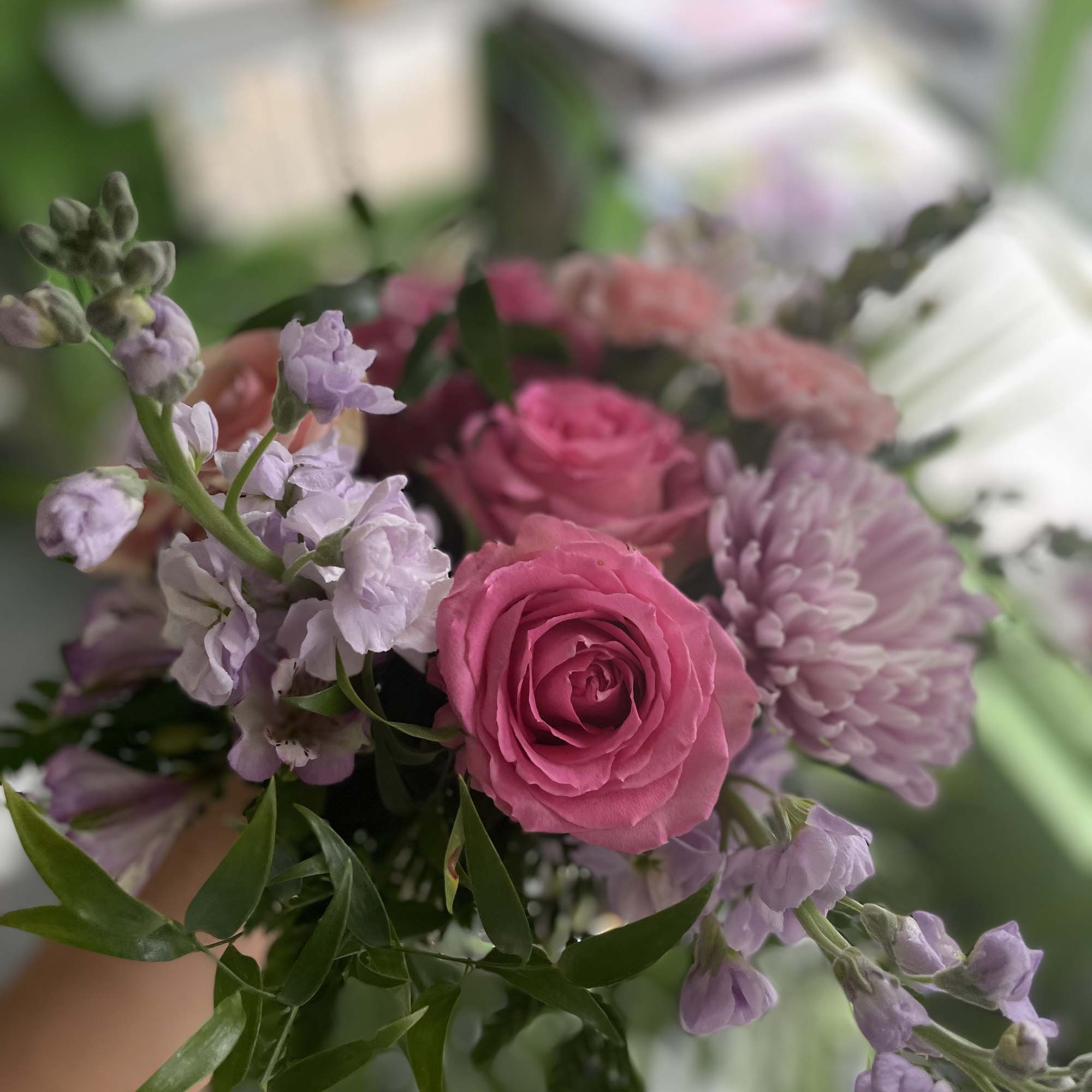 This beautiful arrangement has a pink spray rose, pink hydrangea, lavender stock