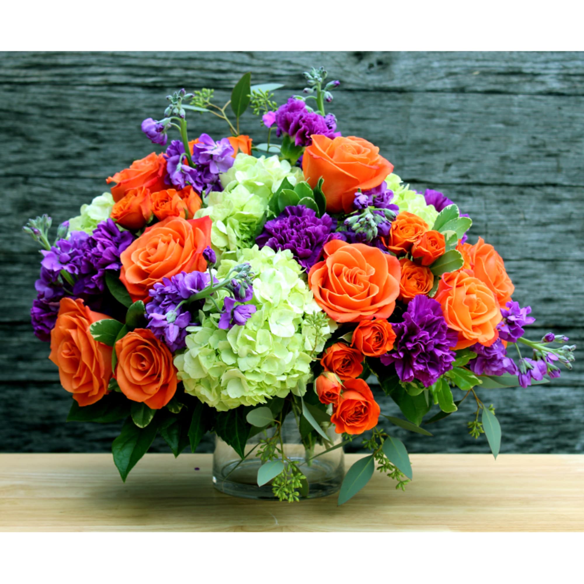 This bright and vibrant arrangement will liven up any room. Orange roses