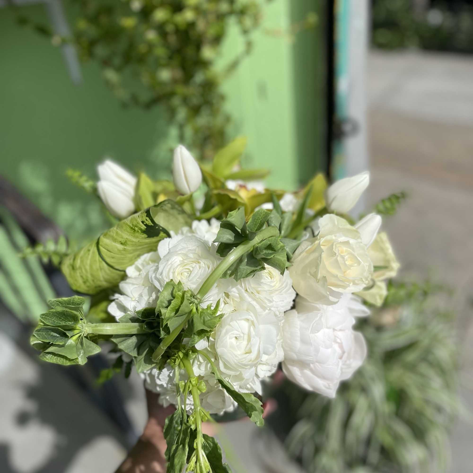 This beautiful arrangement has nice colors of flowers it has green orchid