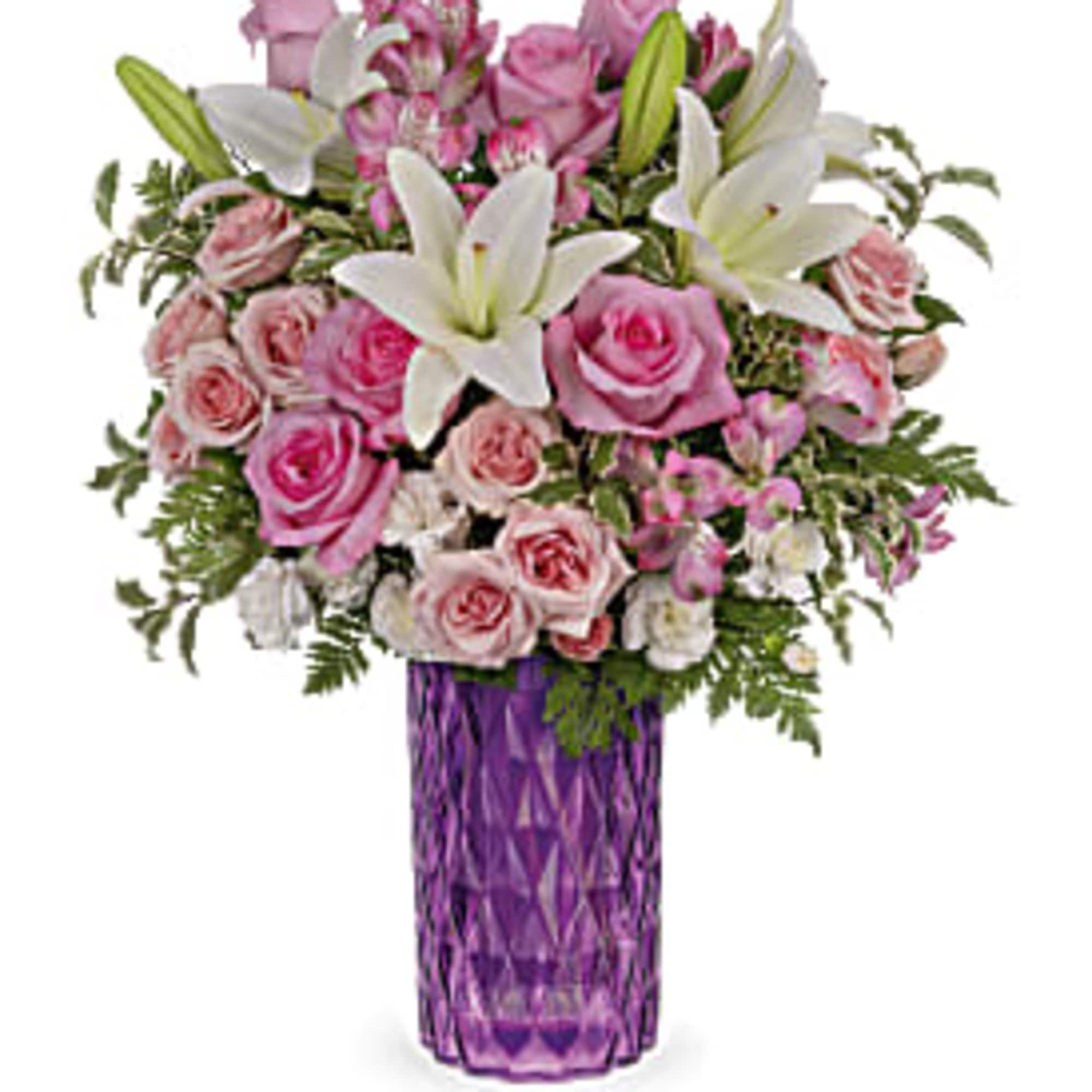 Bursting with perfect pink roses and snow white lilies, this sparkling cut
