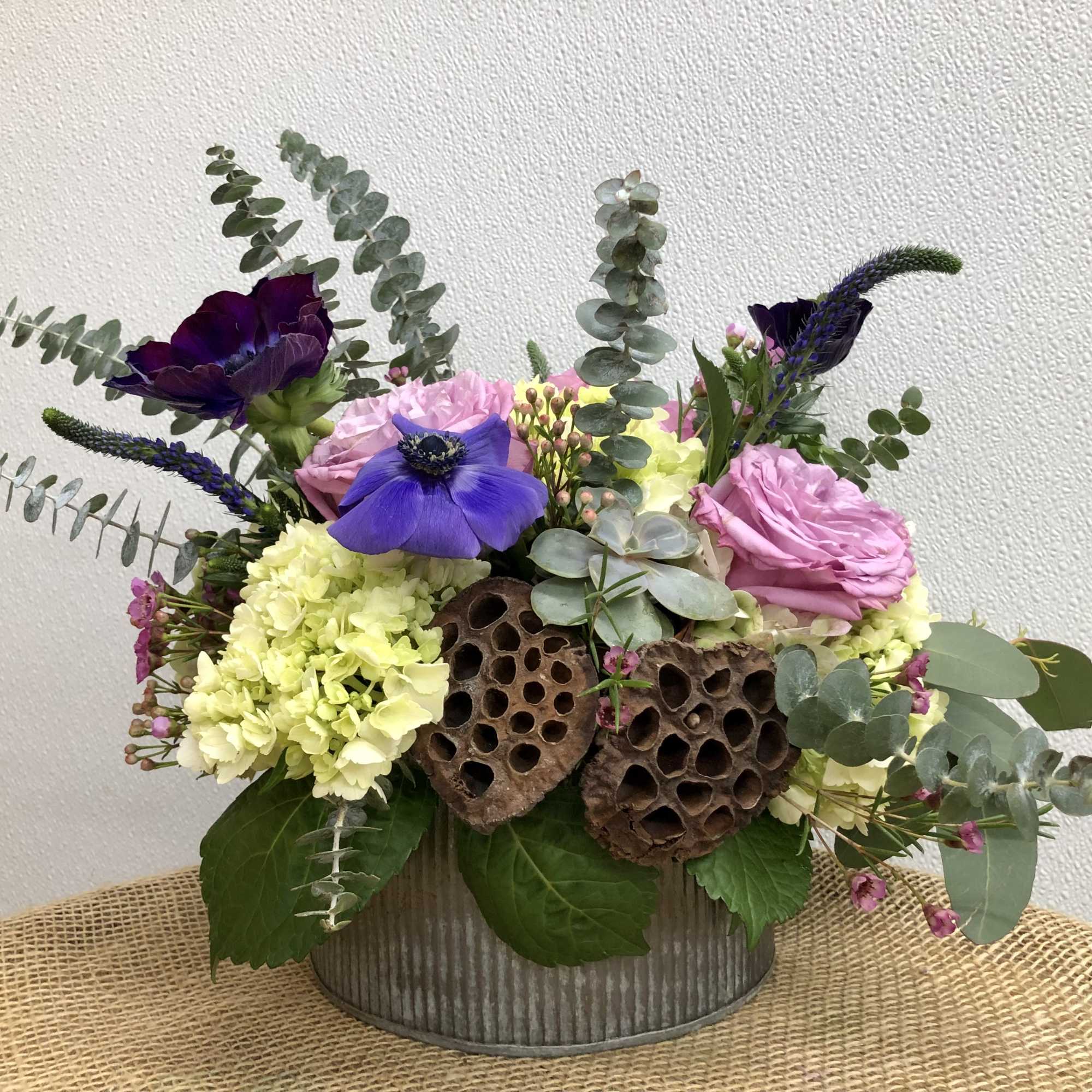 A unique tin container (other vases available) filled with seasonal flowers &amp;