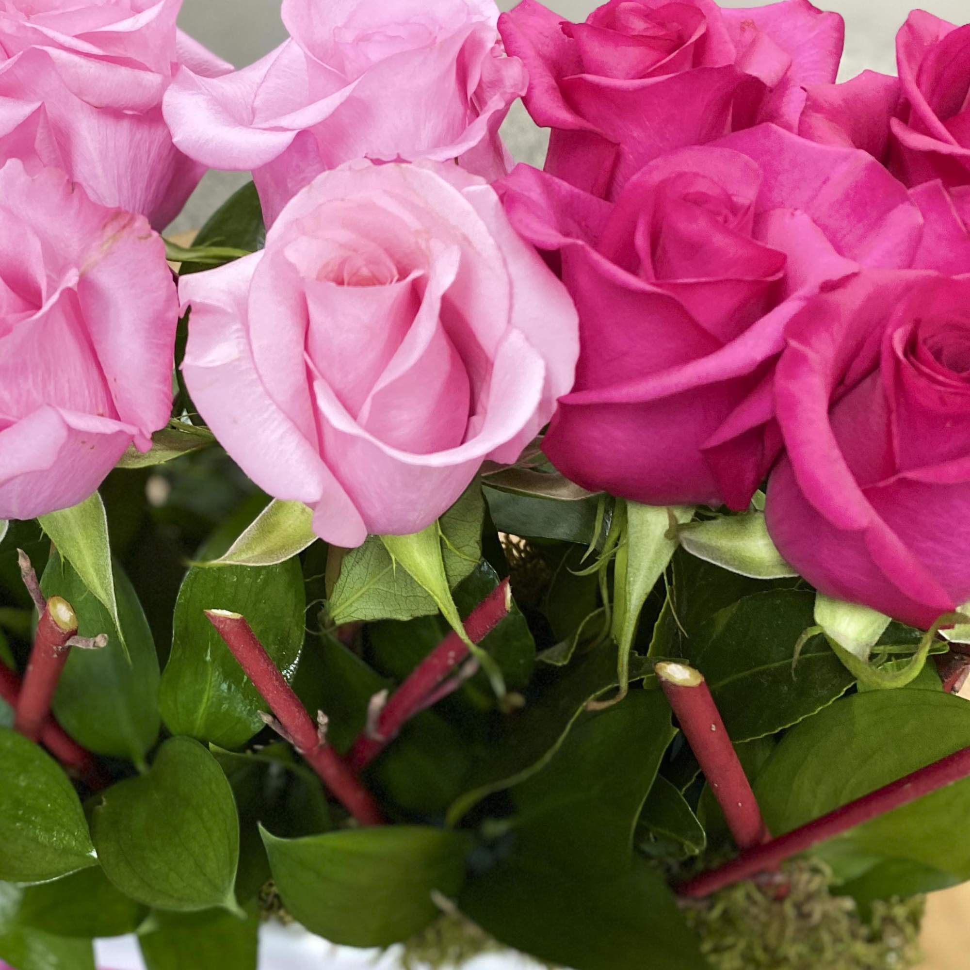 12 roses in 3 tones of pink designed in a vase with