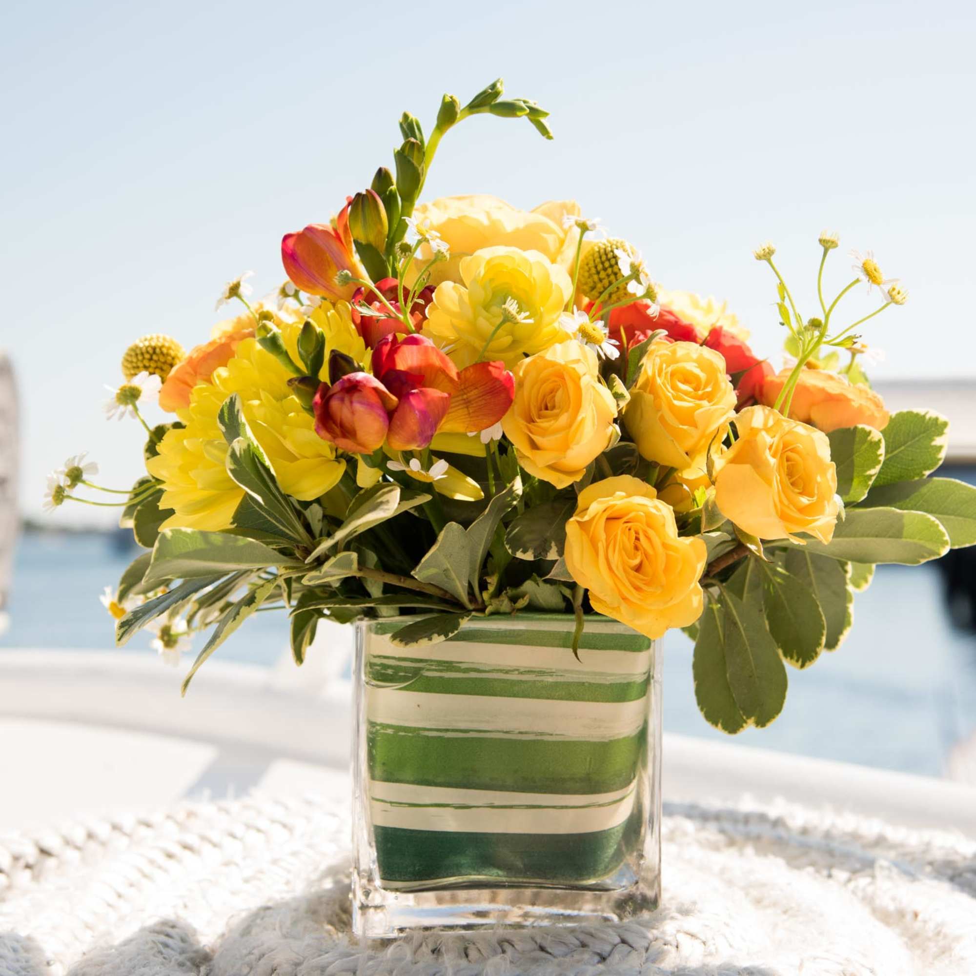 We designed these vibrant centerpieces with a variety of fresh yellows, oranges