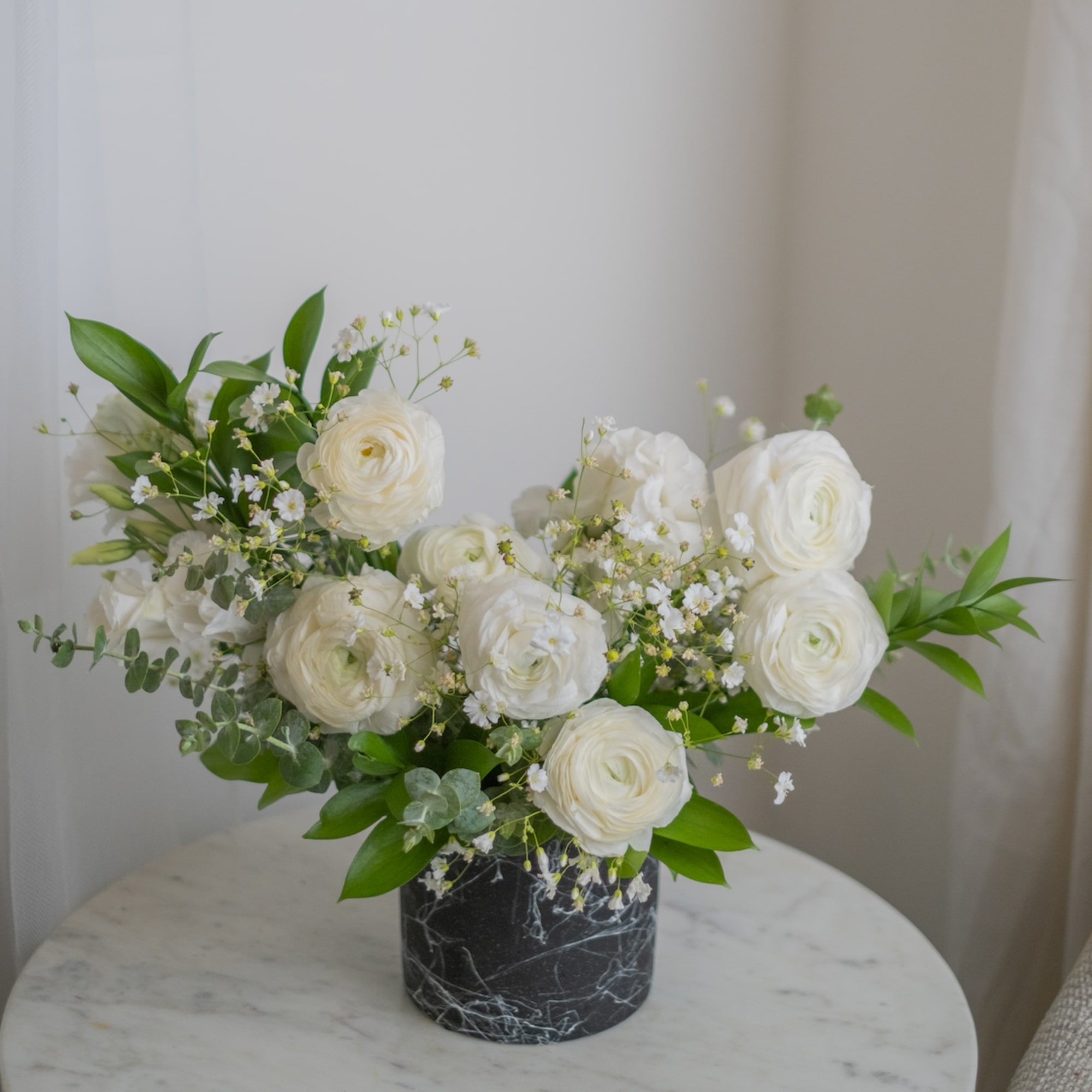 Large inflorescence of white rununculuses fascinate with lightness and airiness and creates