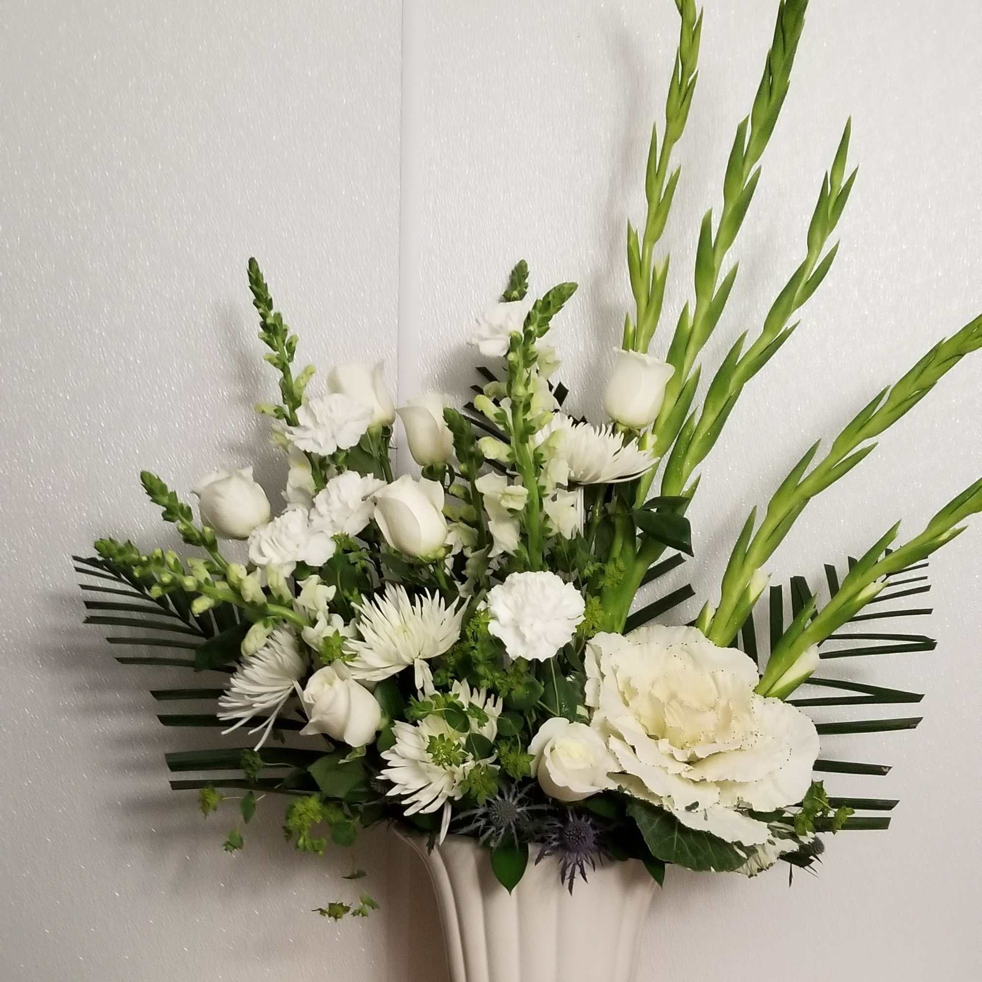 A large white arrangement is suitable for a memorial service to honor
