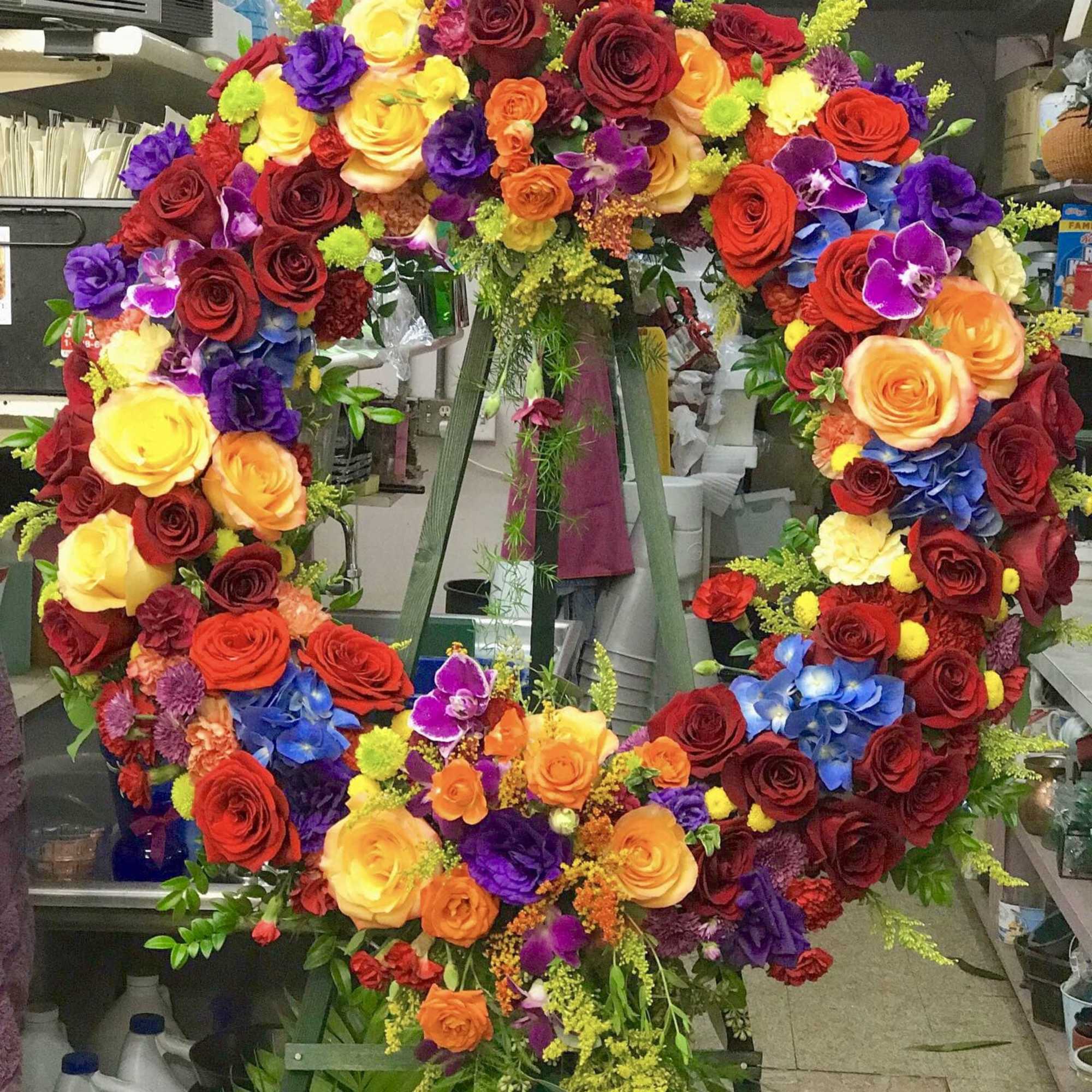 Warm jewel toned fresh flower sympathy easel.